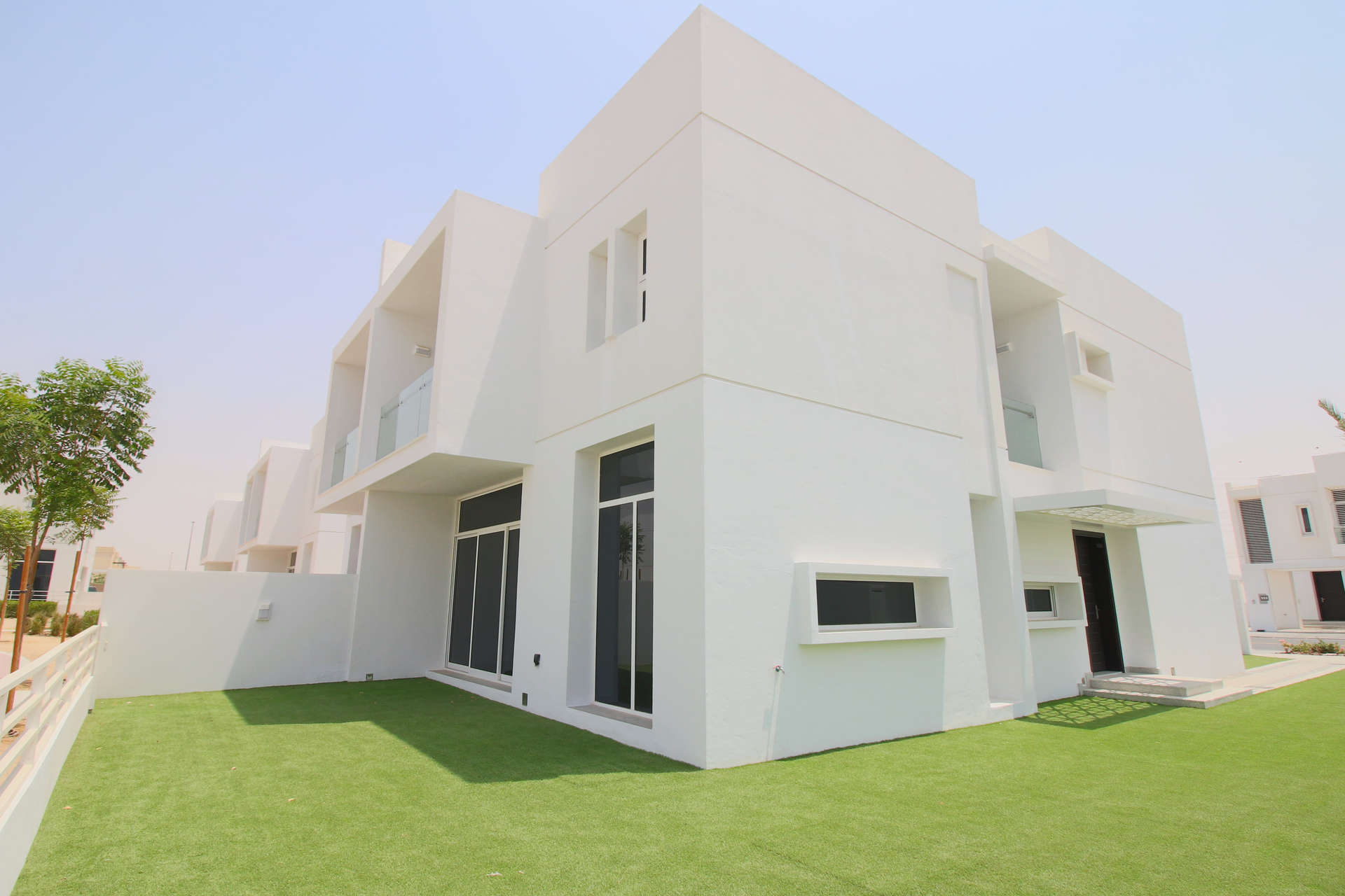 Tennis and basketball court at Arabella 1, Mudon, with modern villas in the background