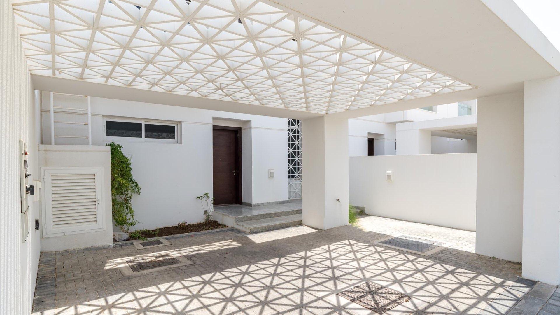 Exterior view of spacious villa yard in Arabella Townhouses, Mudon community