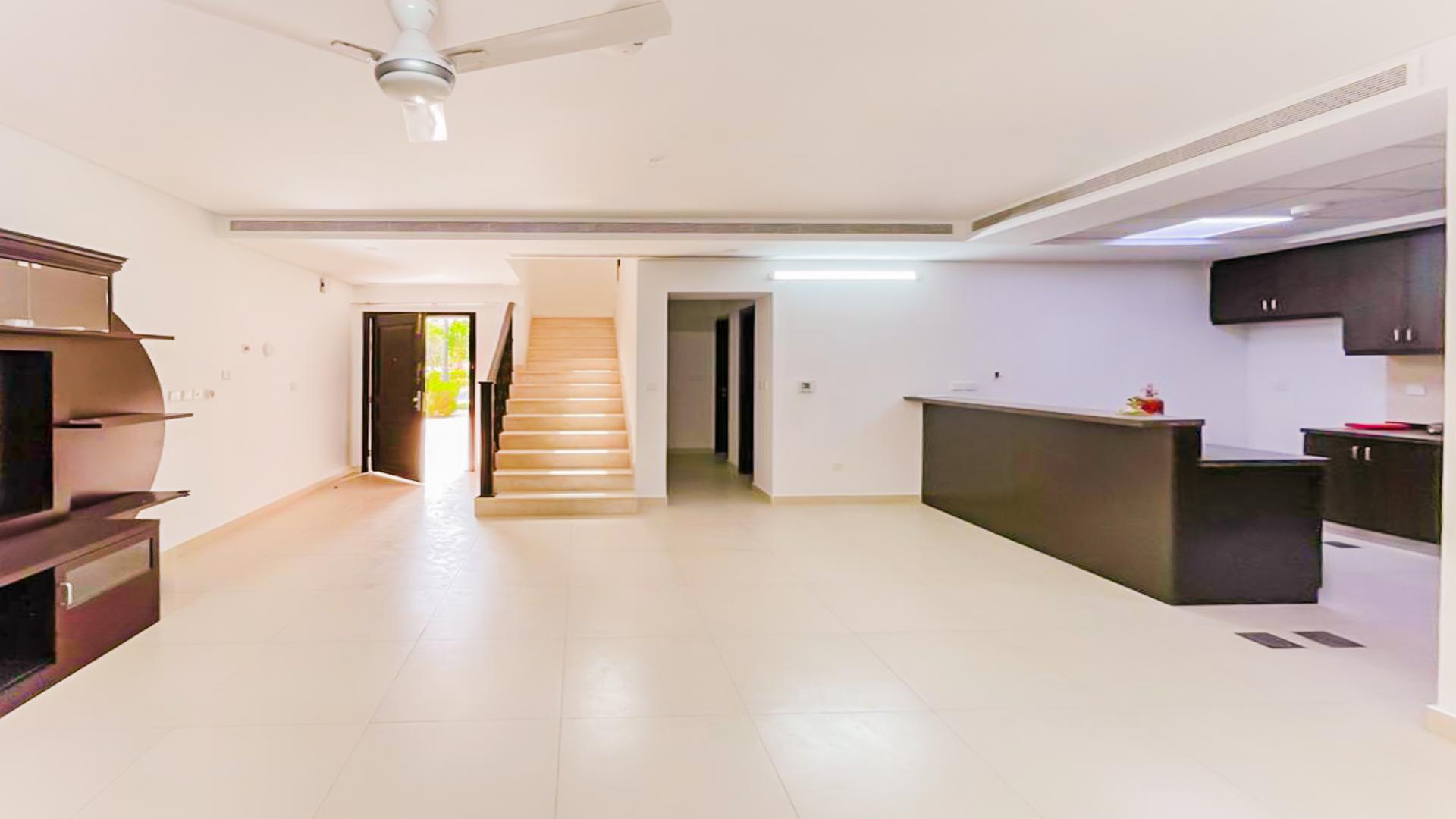 Open-plan living room and kitchen in Serena Bella Casa townhouse for rent