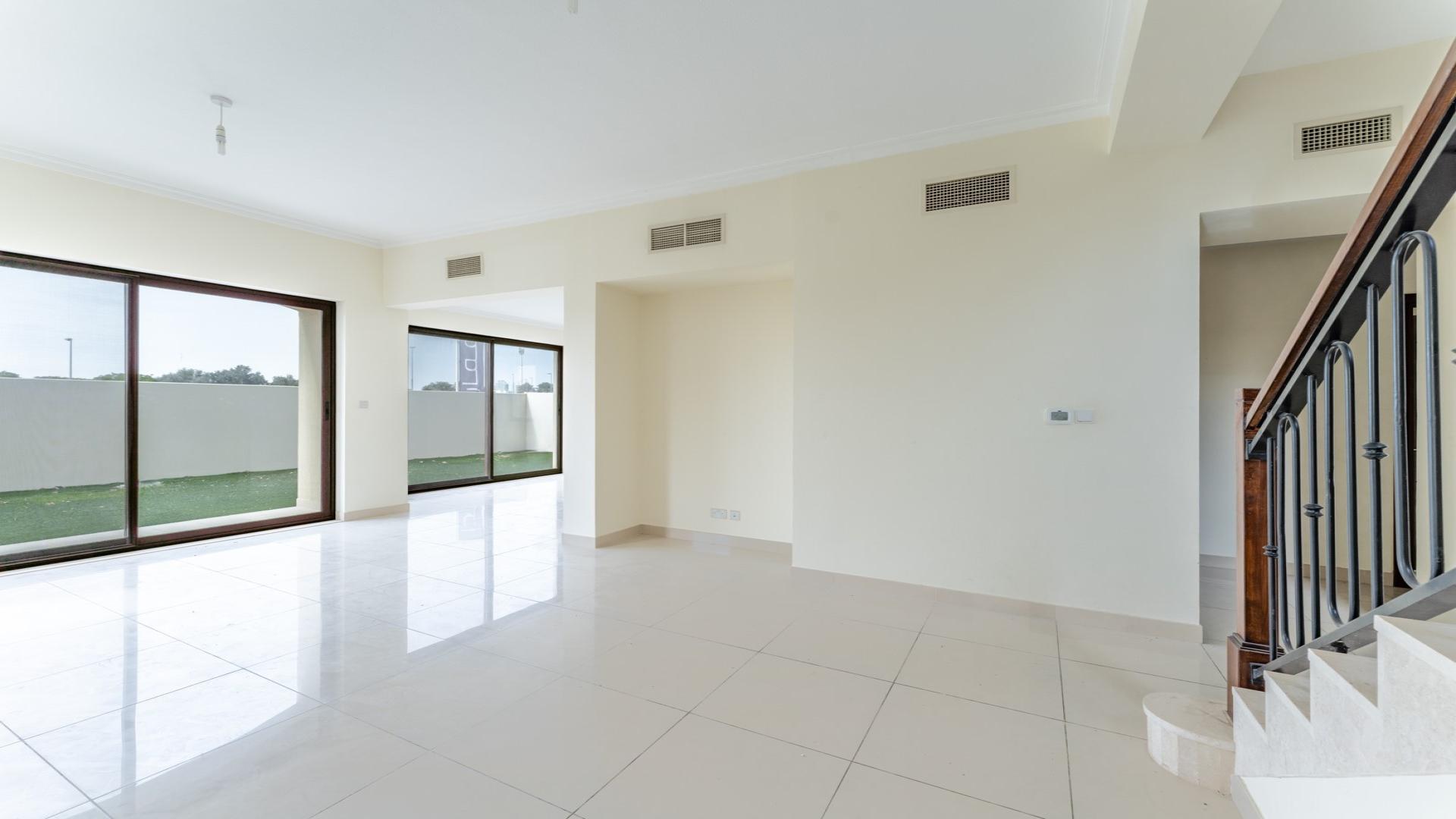 "Spacious interior of 3-bedroom villa in Samara, Arabian Ranches 2, with modern staircase.",Spacious living room in Samara 3-bedroom villa, Arabian Ranches 2, with large windows