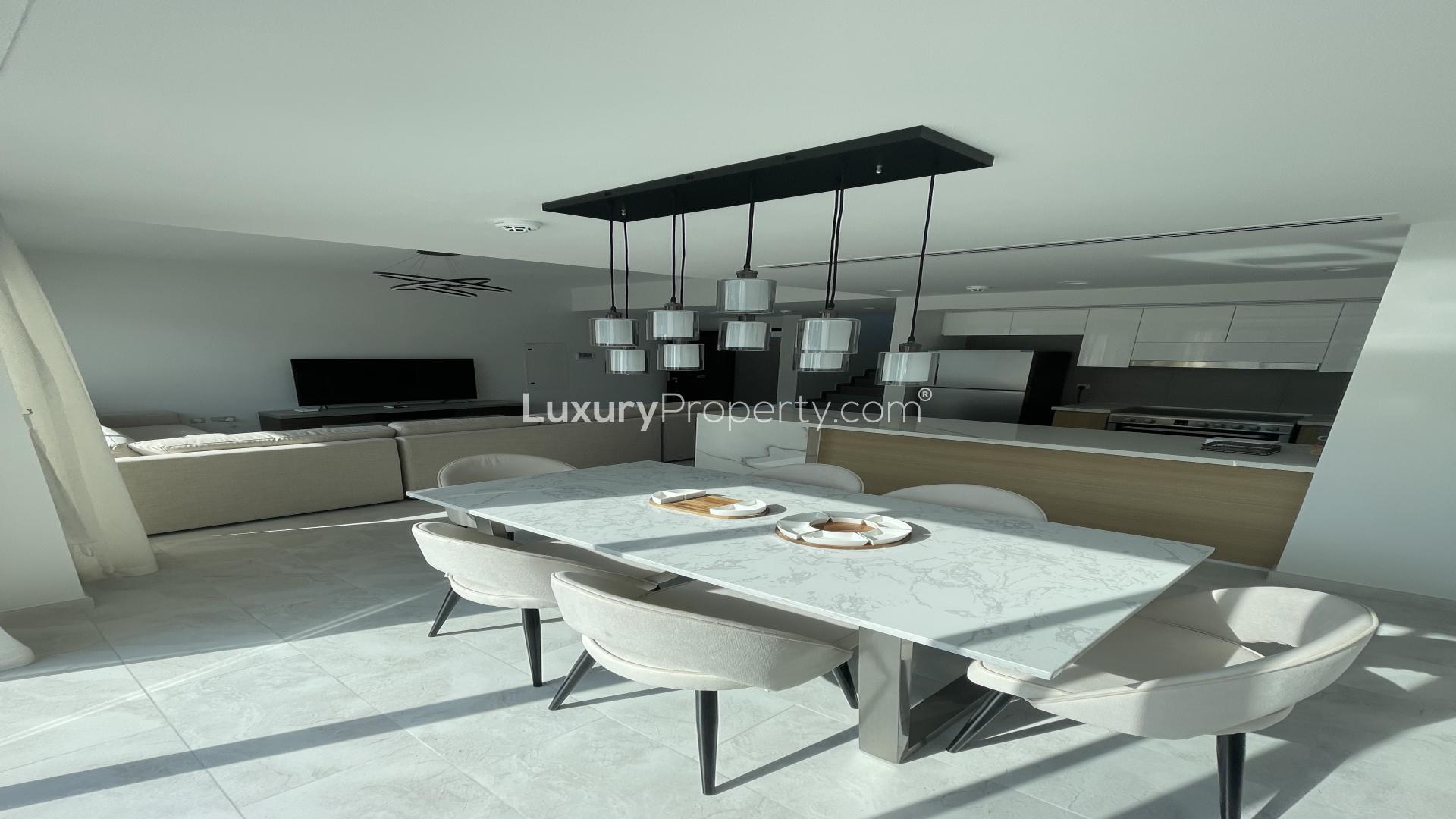 Modern living room in La Rosa villa, Dubai Land, featuring spacious layout and natural light