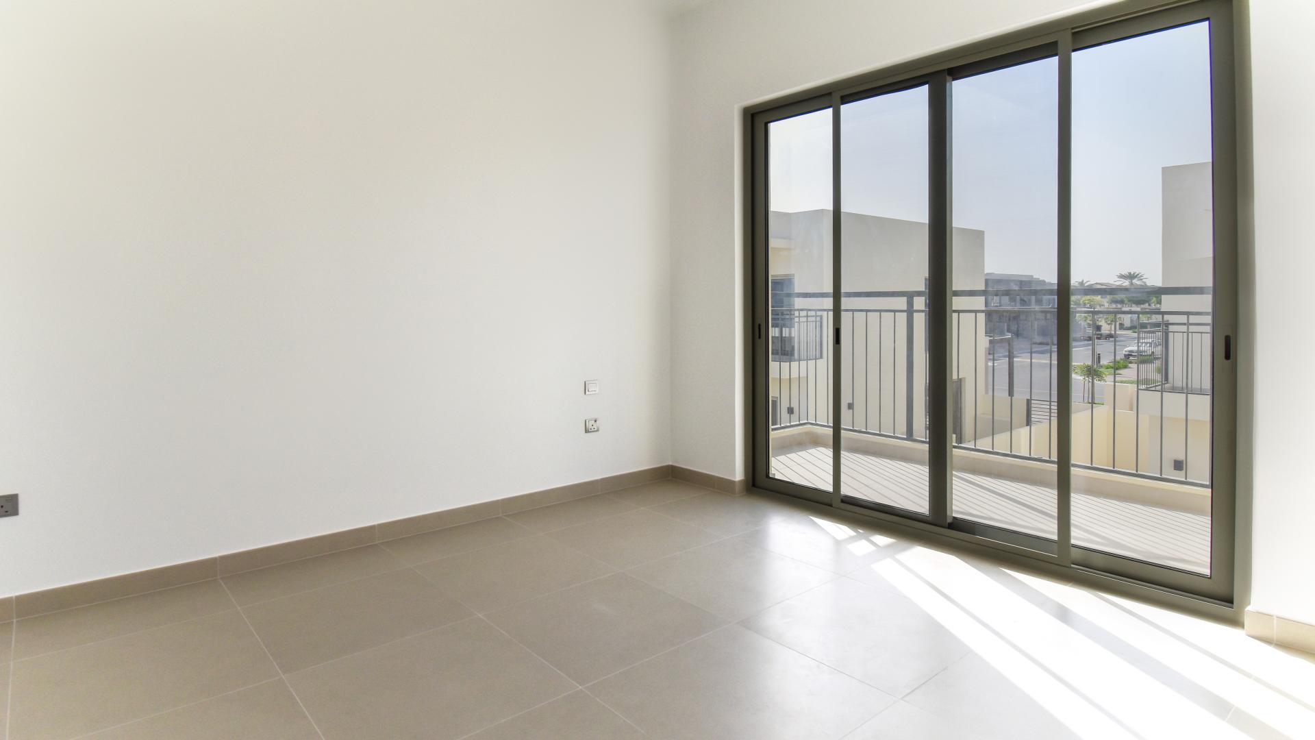 Exterior view of modern townhouse in Camelia, Arabian Ranches 2, featuring spacious driveway