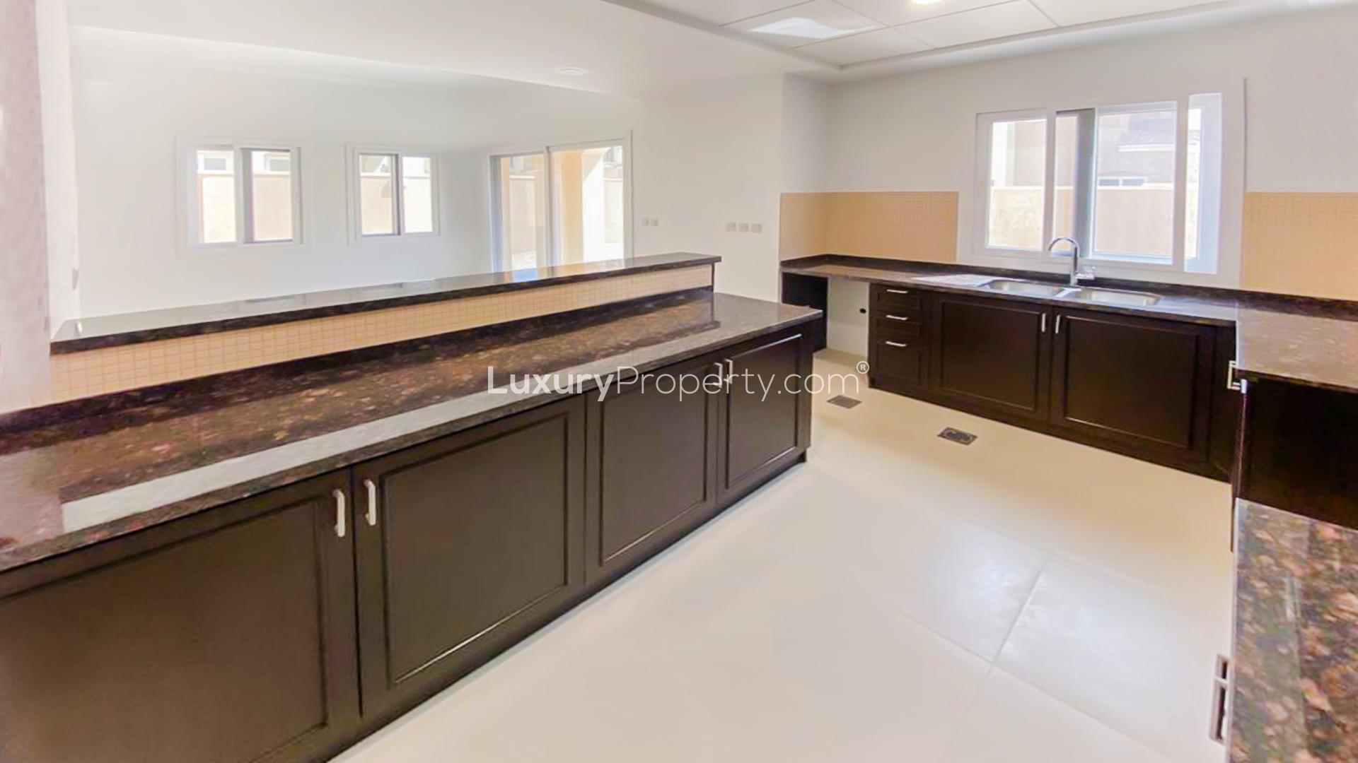 Modern kitchen with dark wood cabinets in Serena Casa Viva villa, Dubai for rent