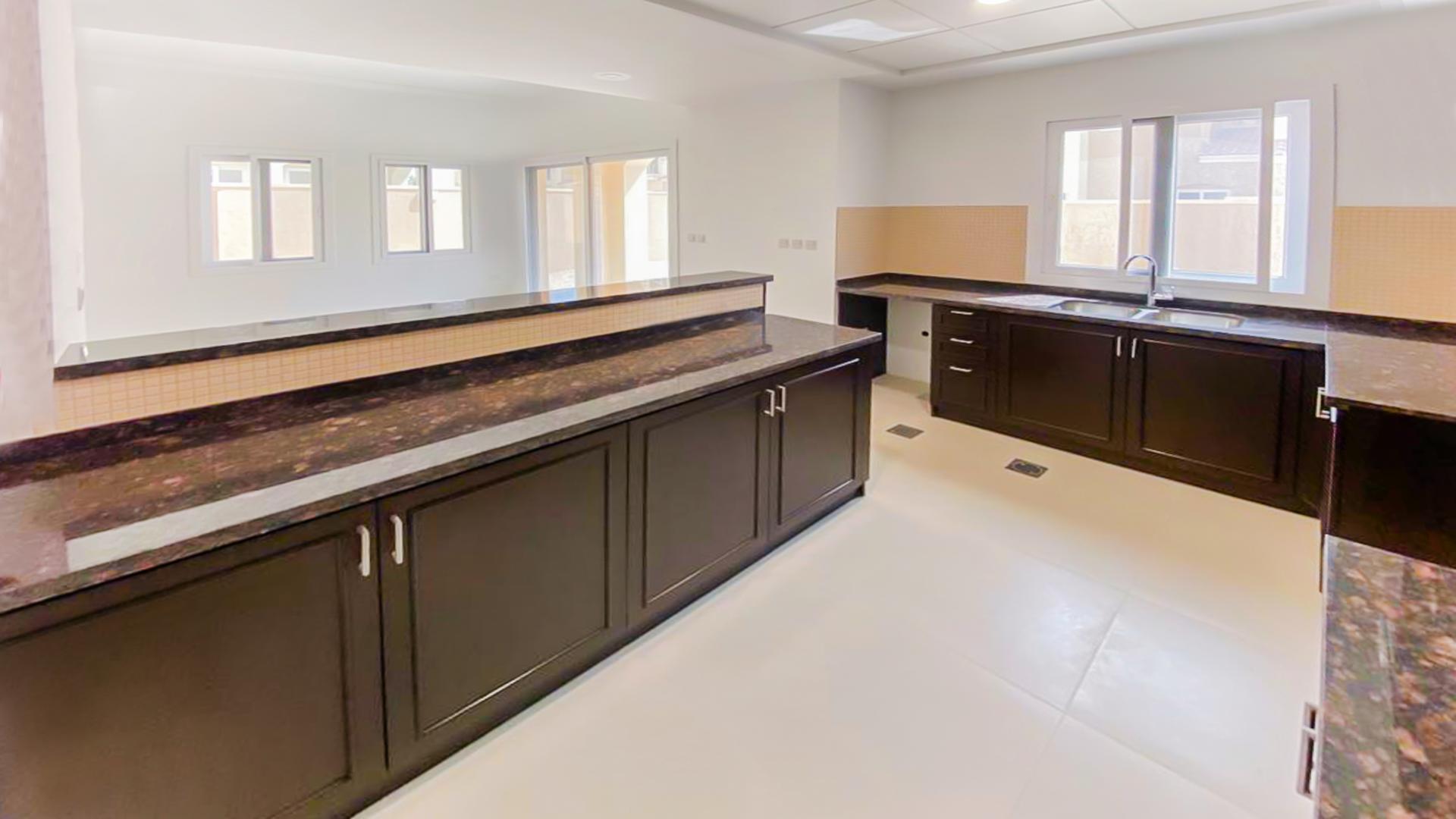 Modern kitchen with dark wood cabinets in Serena Casa Viva villa, Dubai for rent
