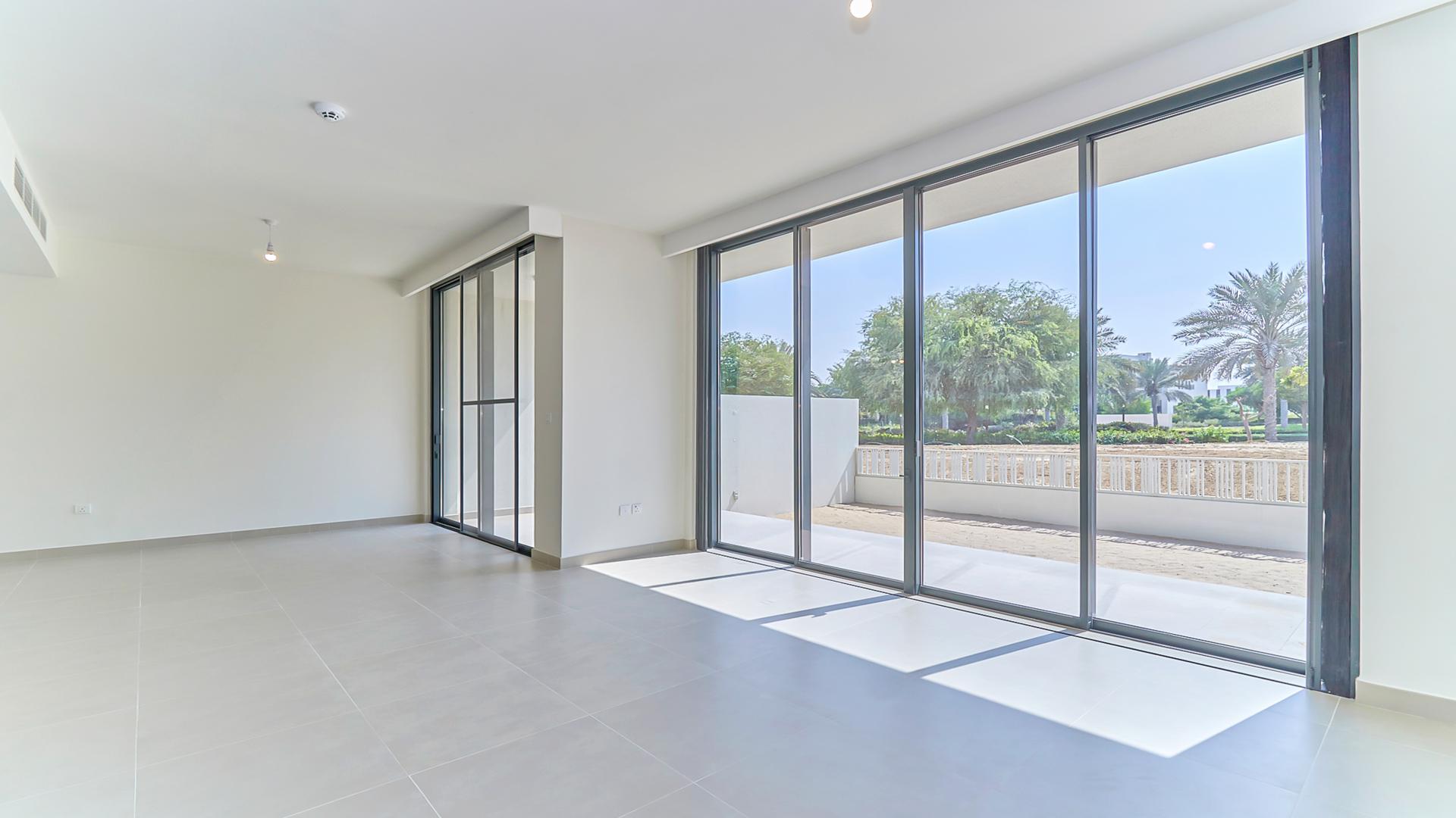 Modern kitchen in Dubai Hills Estate villa with large windows and garden view