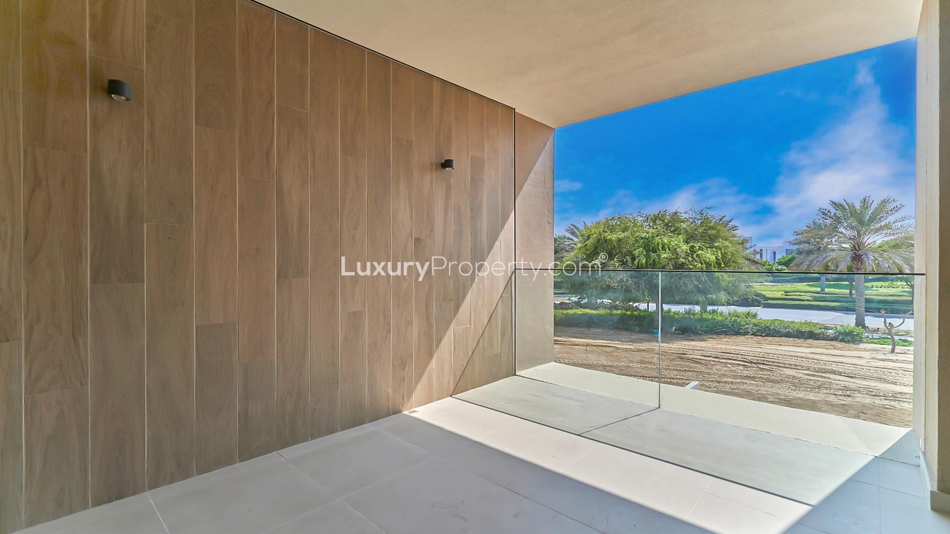 Modern villa exterior at Club Villas, Dubai Hills Estate, with rooftop terrace and park view