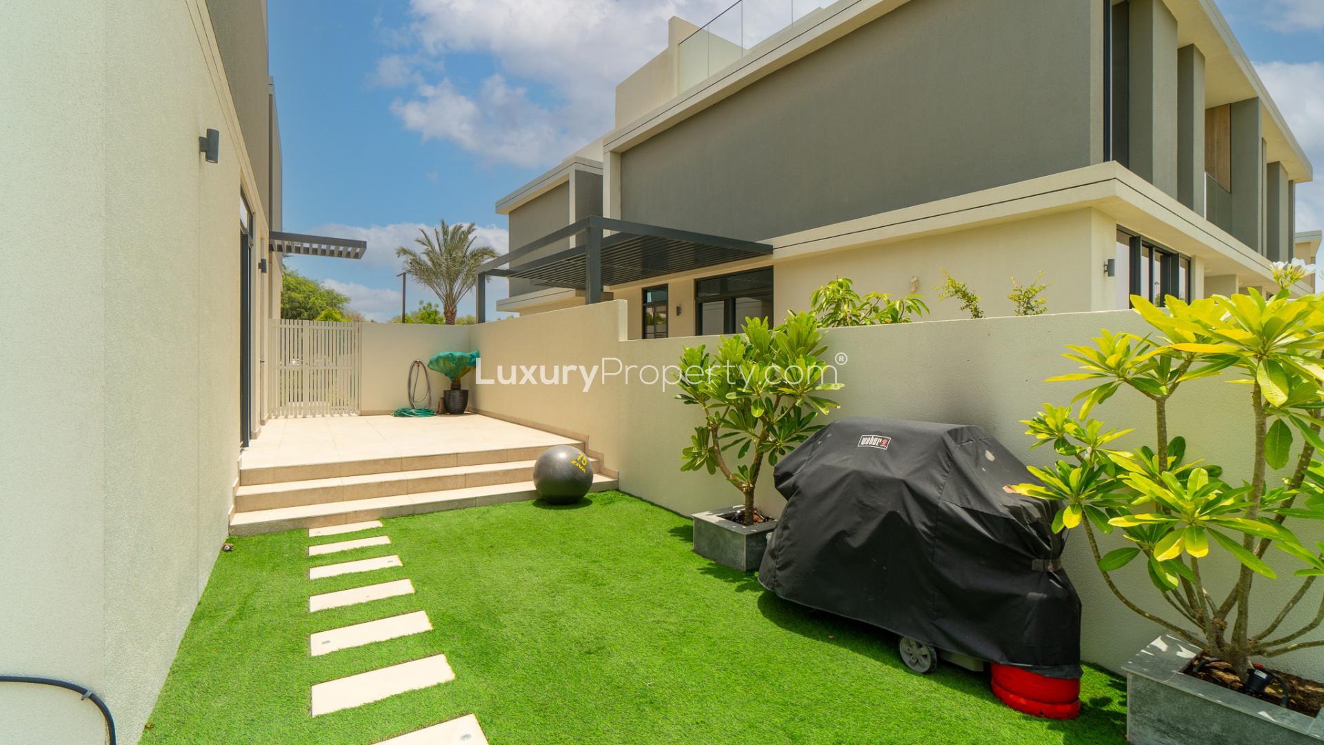 "Modern villa patio with landscaped garden in Dubai Hills Estate, Club Villas community.",Brand new Club Villa terrace view overlooking golf course in Dubai Hills Estate