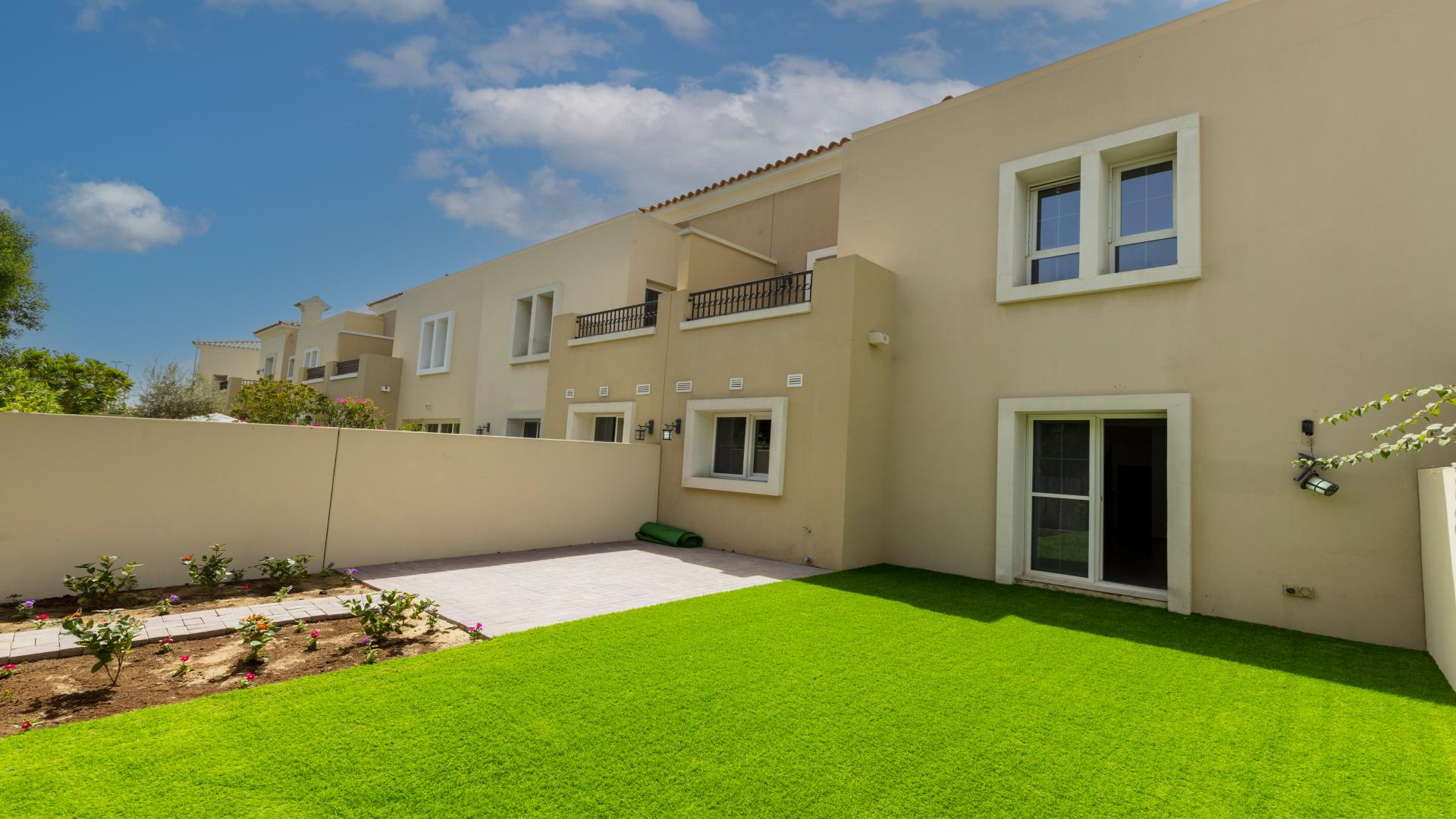Spacious living room in Forat villa, The Lakes, with garden view through large window