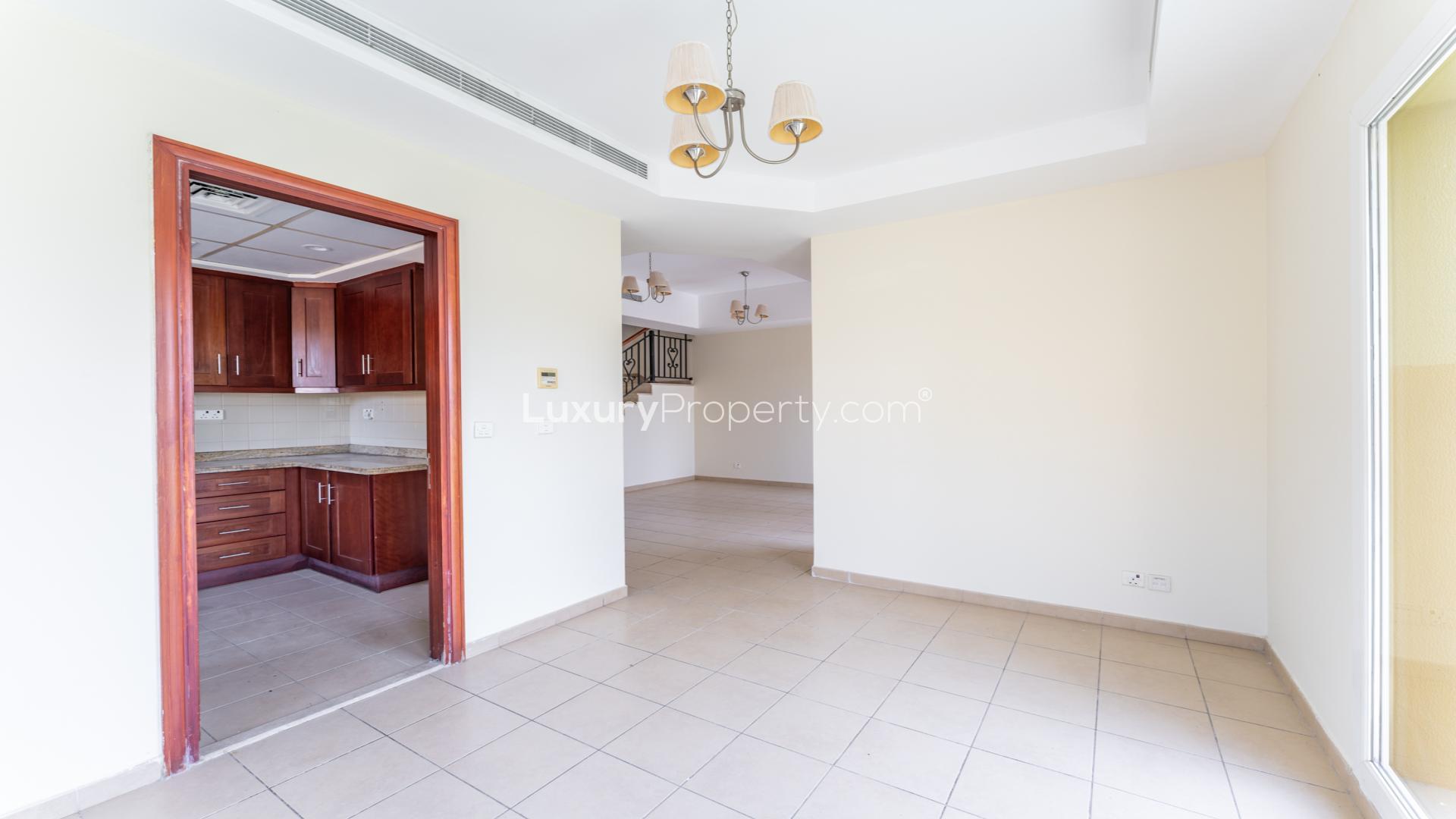 Charming villa kitchen with wooden cabinets and stone countertops in Arabian Ranches, Palmera 3