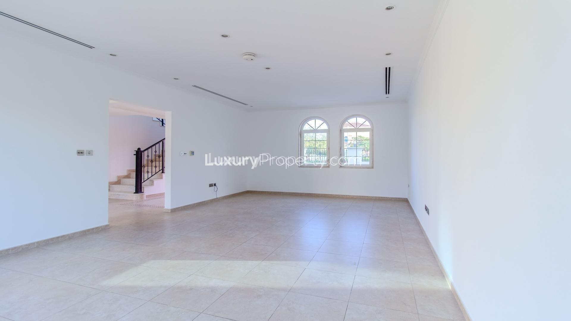 Bright living room with large windows in Jumeirah Park Legacy villa for rent