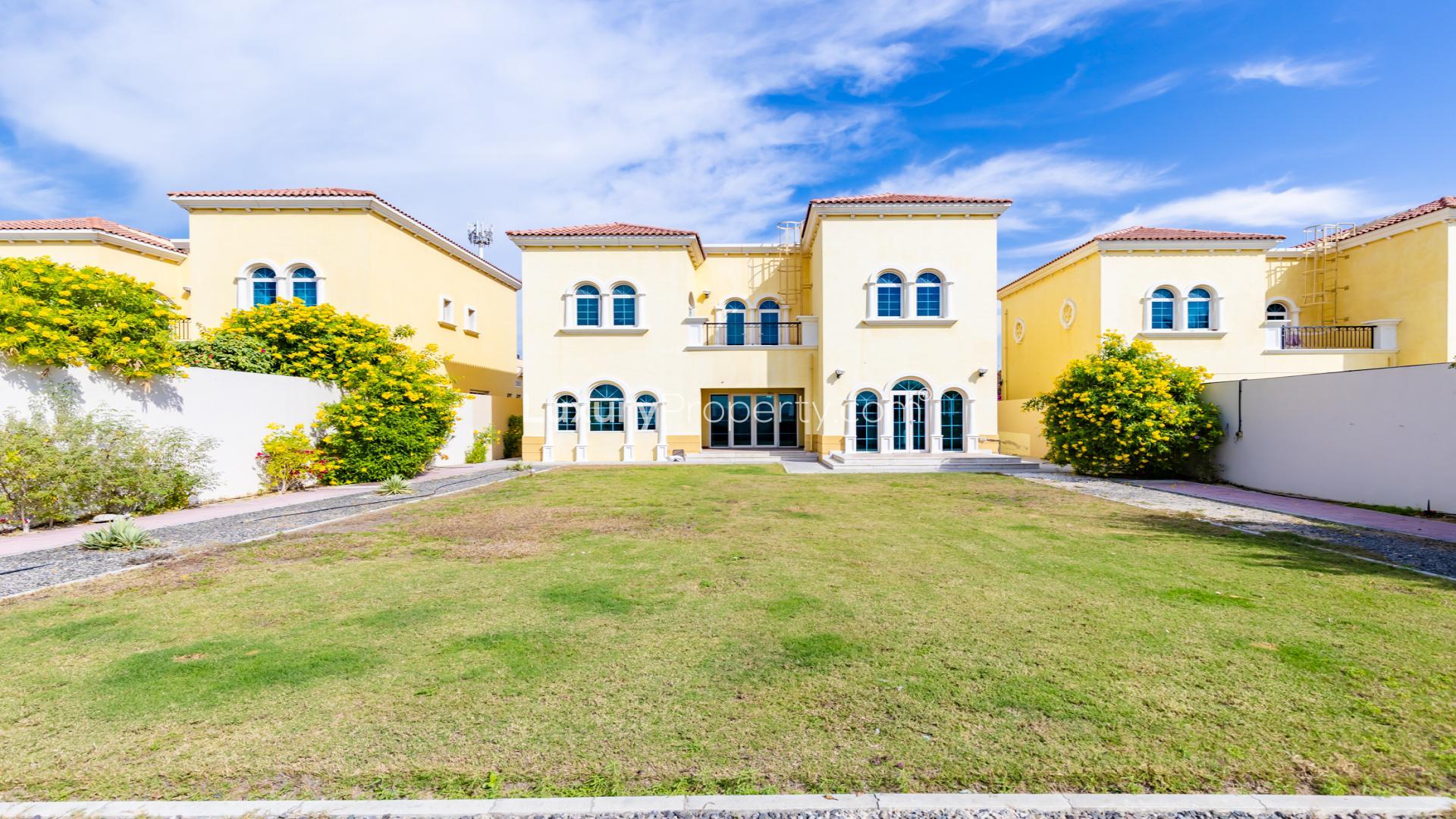 Beautiful villa entrance with vibrant garden in Jumeirah Park's Legacy community for rent