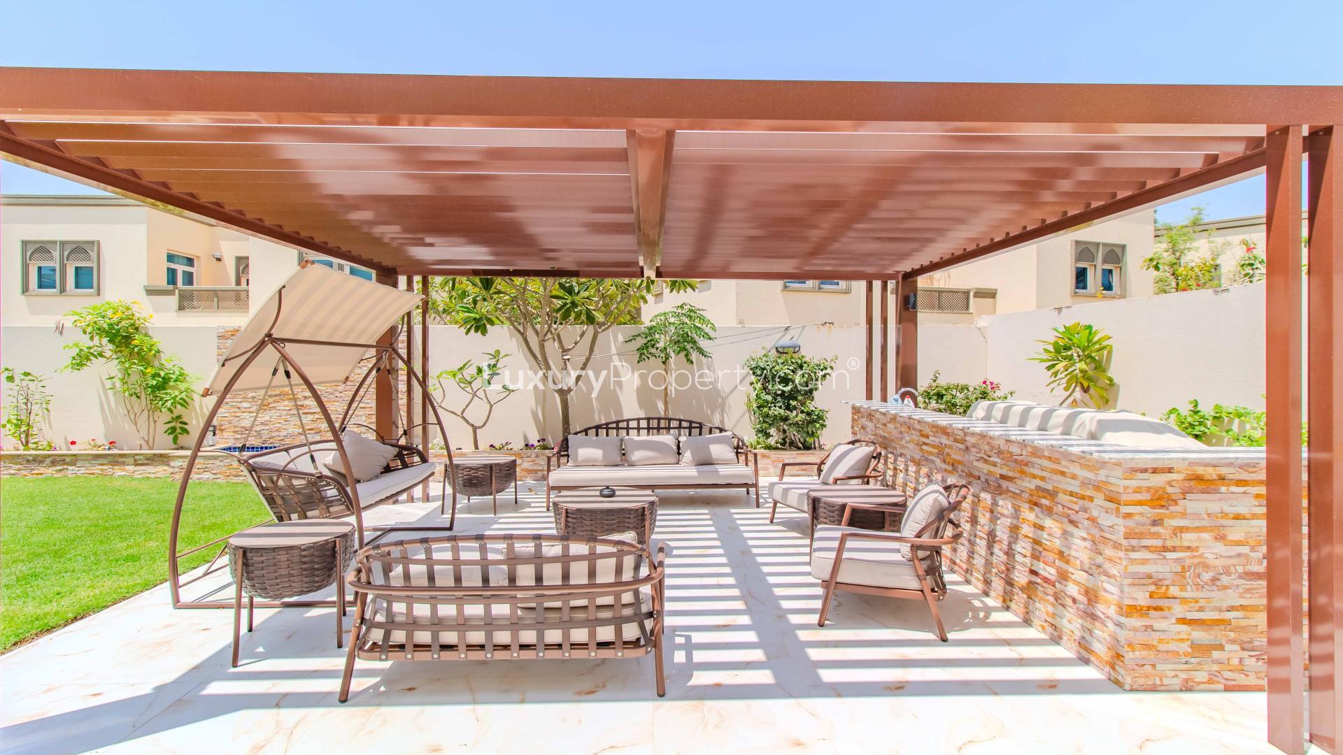 Exterior view of Jumeirah Park Legacy Villa with lush garden and patio area