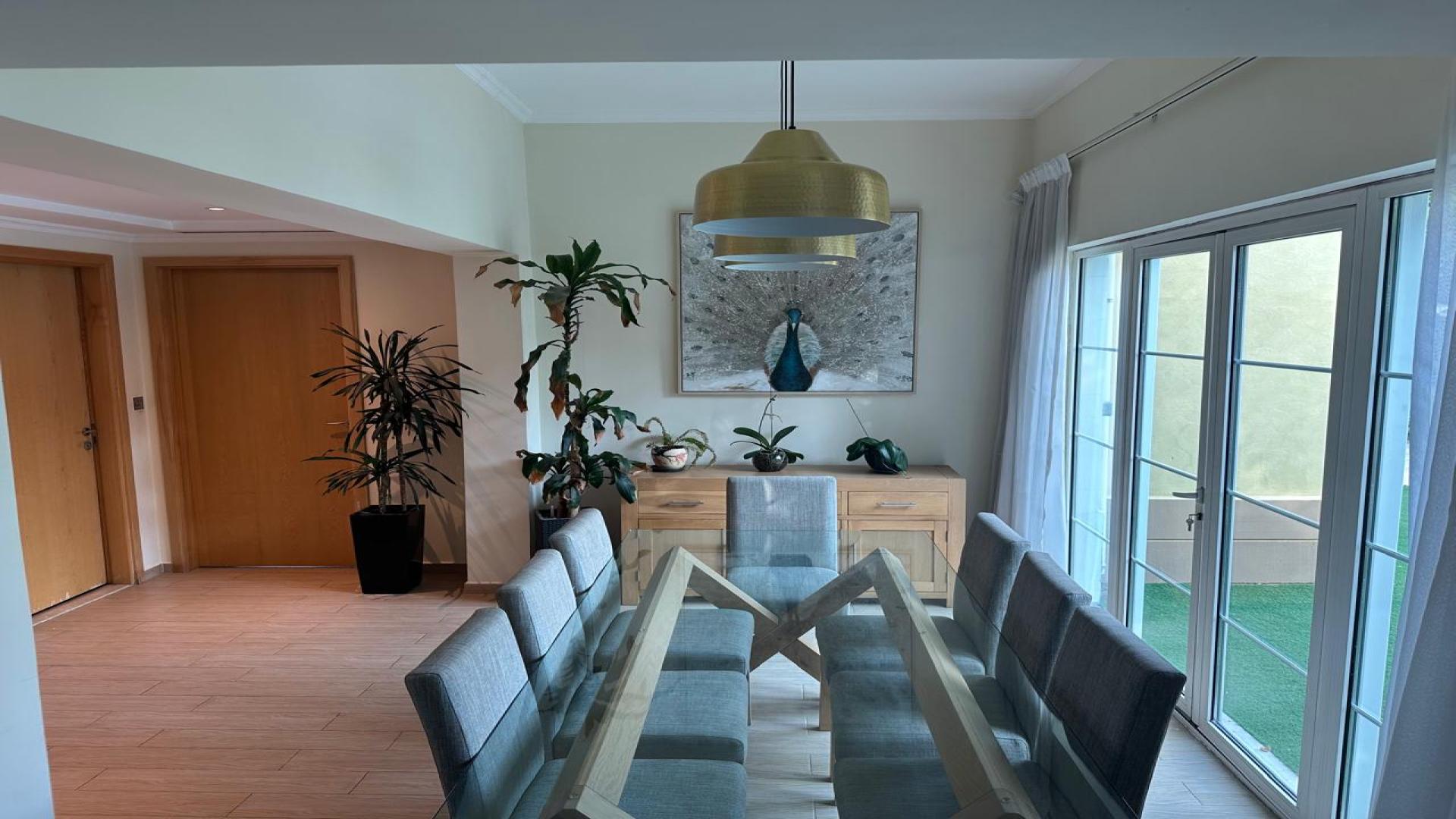 Spacious living room in 3-bedroom villa, Jumeirah Park, Legacy, with modern decor and large windows