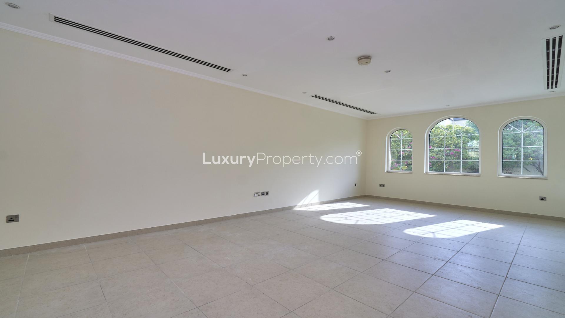 Spacious living room in Jumeirah Park Legacy villa with large windows and natural light