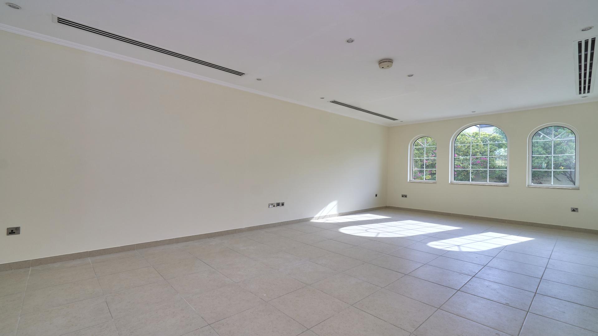 Spacious living room in Jumeirah Park Legacy villa with large windows and natural light