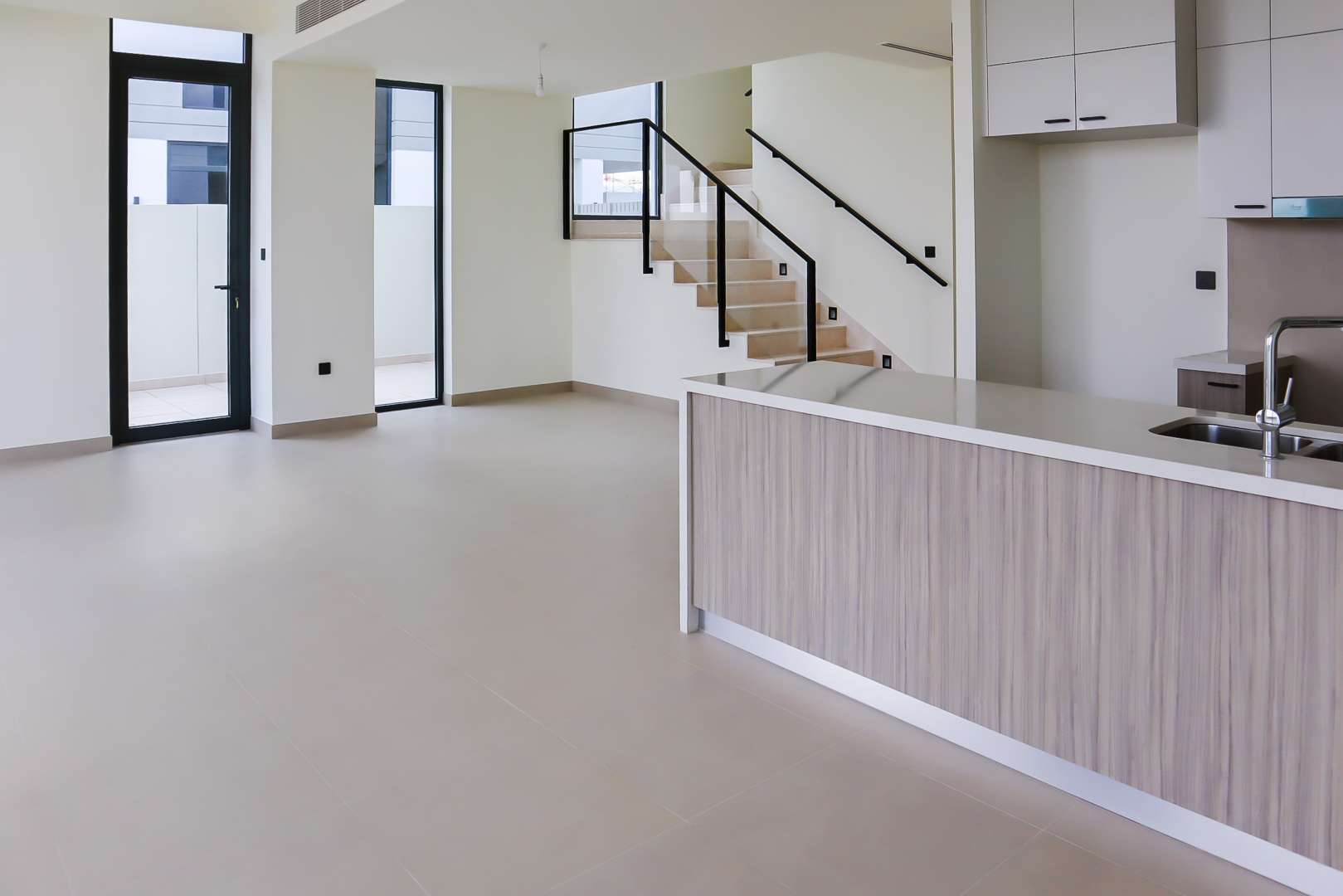 "Spacious patio view of 3-bedroom villa in Golf Grove, Dubai Hills Estate for rent.",Modern kitchen and living area in Golf Grove villa, Dubai Hills Estate, for rent