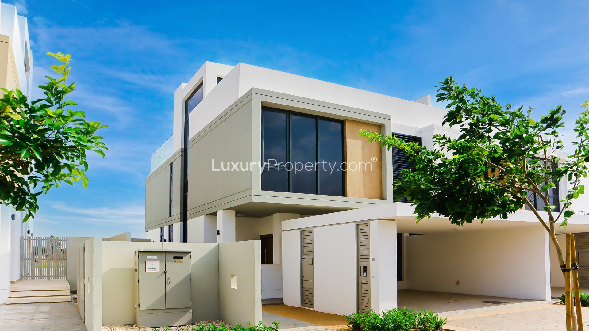 Modern open-plan kitchen and living area in Dubai Hills Estate villa, Golf Grove community