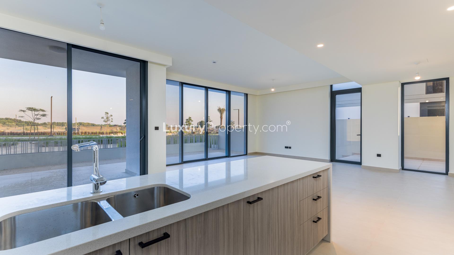 Modern open-plan kitchen and living area in Dubai Hills Estate villa for rent