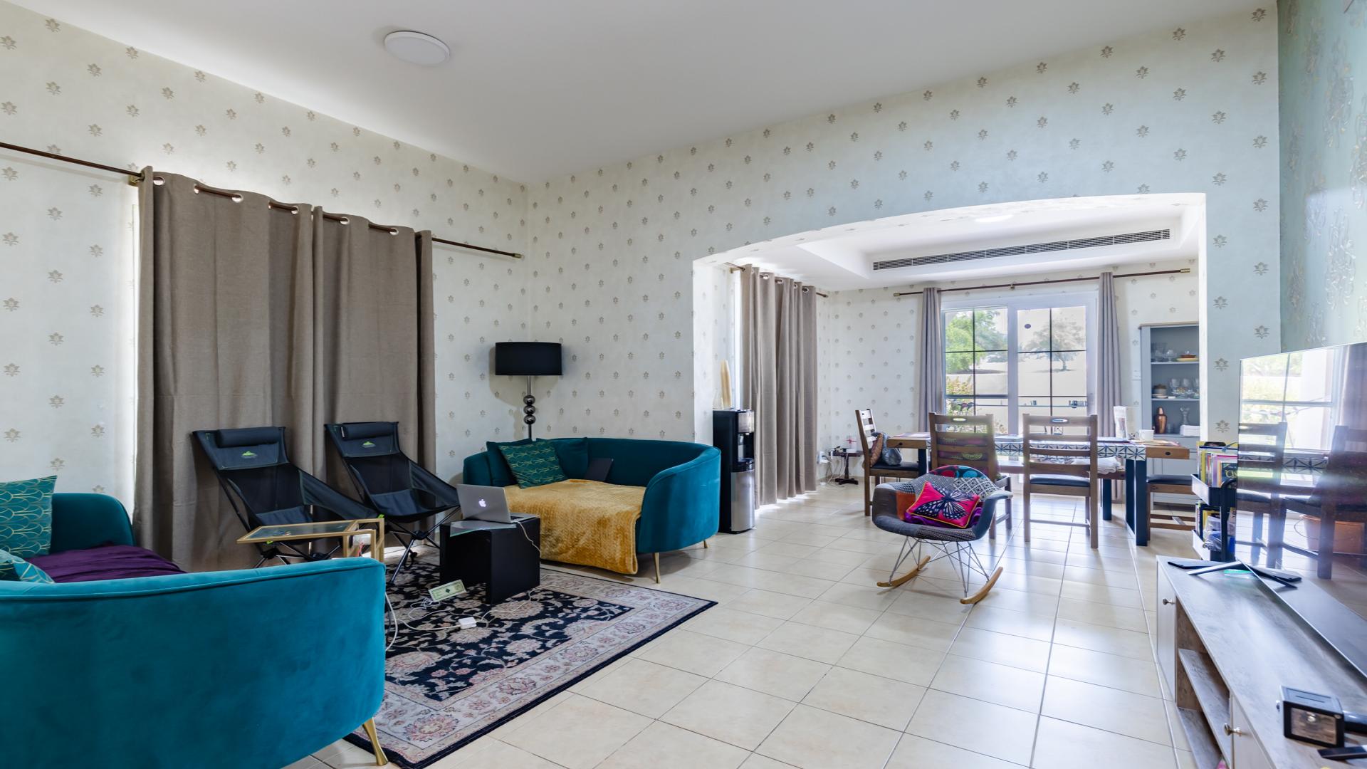 Elegant villa exterior in Al Reem, Arabian Ranches, featuring lush greenery and modern design