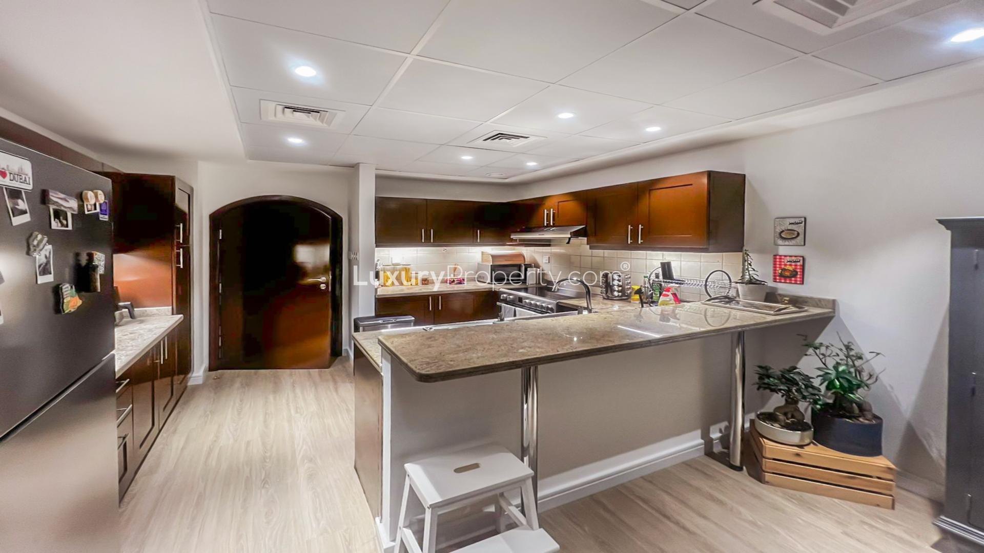 Modern kitchen in 3-bedroom villa, Al Reem 1, Arabian Ranches, featuring stainless steel appliances