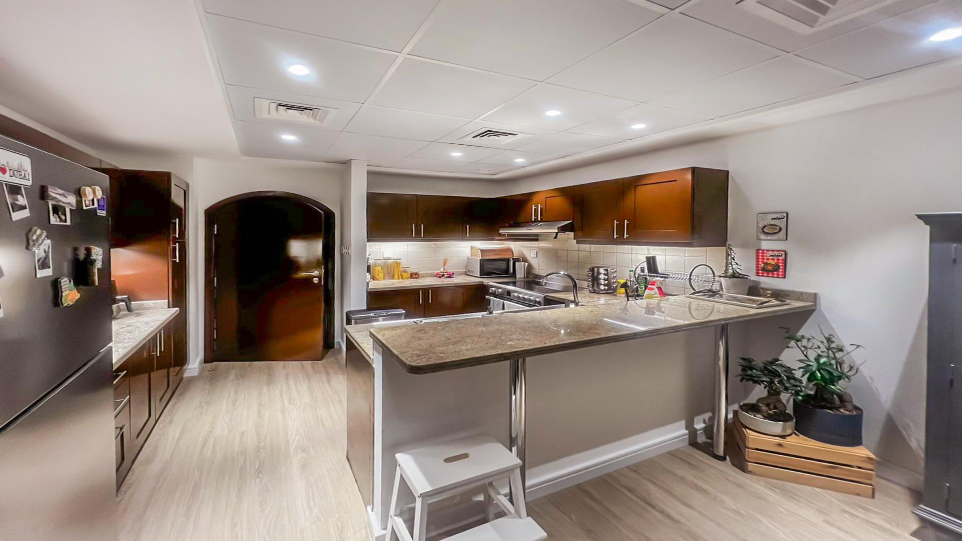 Modern kitchen in 3-bedroom villa, Al Reem 1, Arabian Ranches, featuring stainless steel appliances