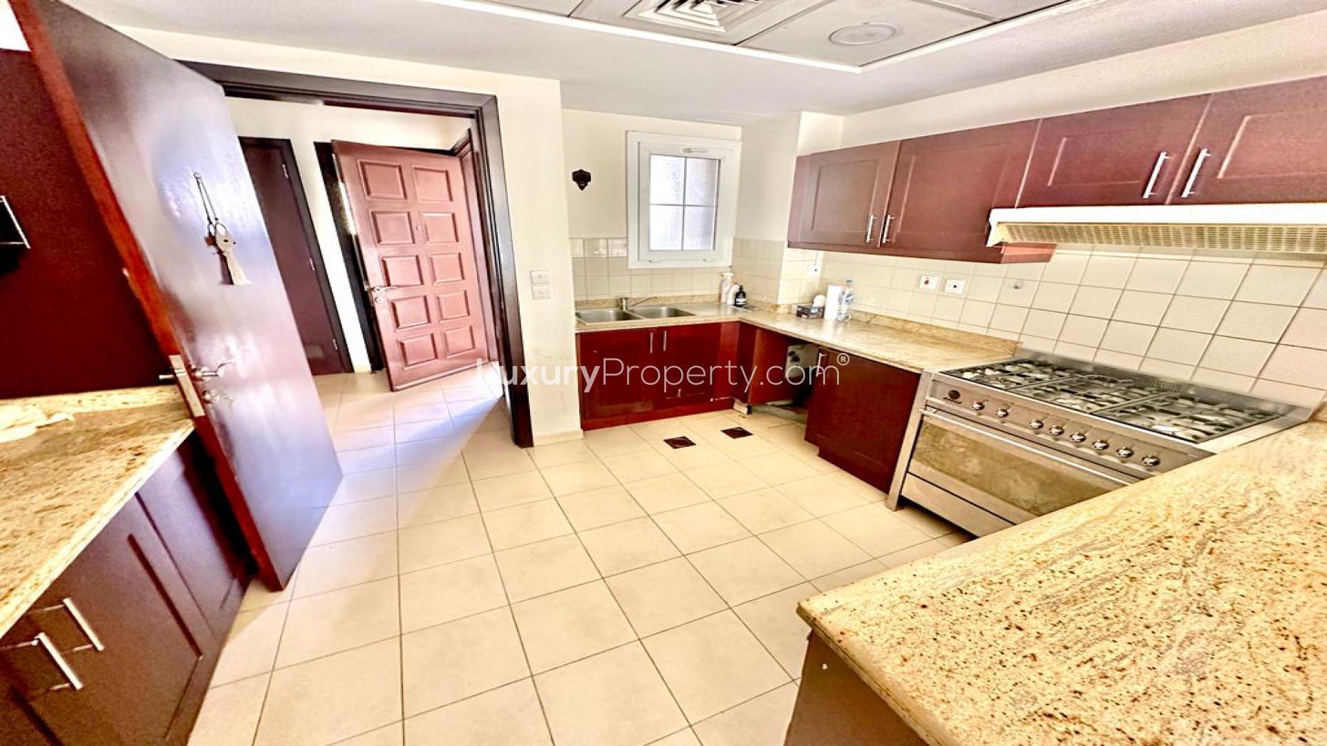 "Spacious villa garden with patio in Al Reem, Arabian Ranches, perfect for family living.",Modern kitchen in Al Reem villa, Arabian Ranches, with granite countertops and wooden cabinets