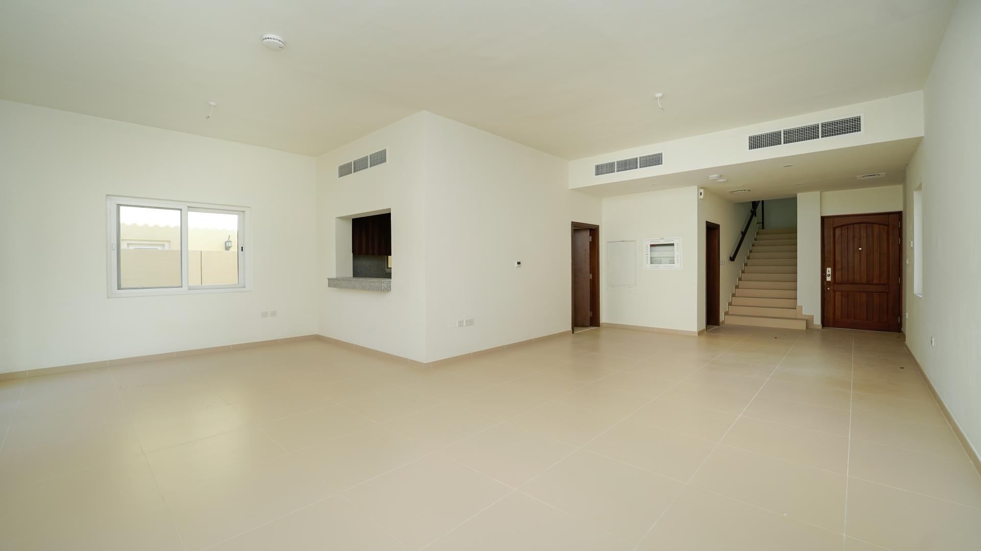 Spacious living area in 3-bed villa, Villanova, Dubai Land, with sliding glass doors
