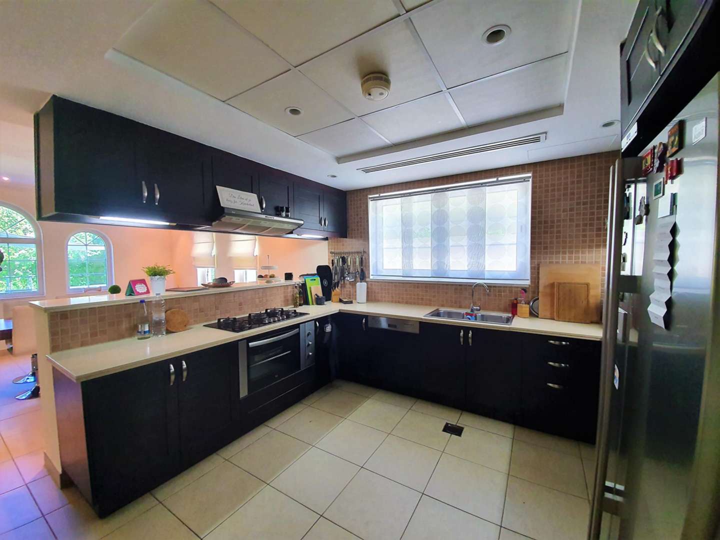 Modern kitchen in 3-bedroom Legacy Large villa, Jumeirah Park, with sleek cabinetry and appliances