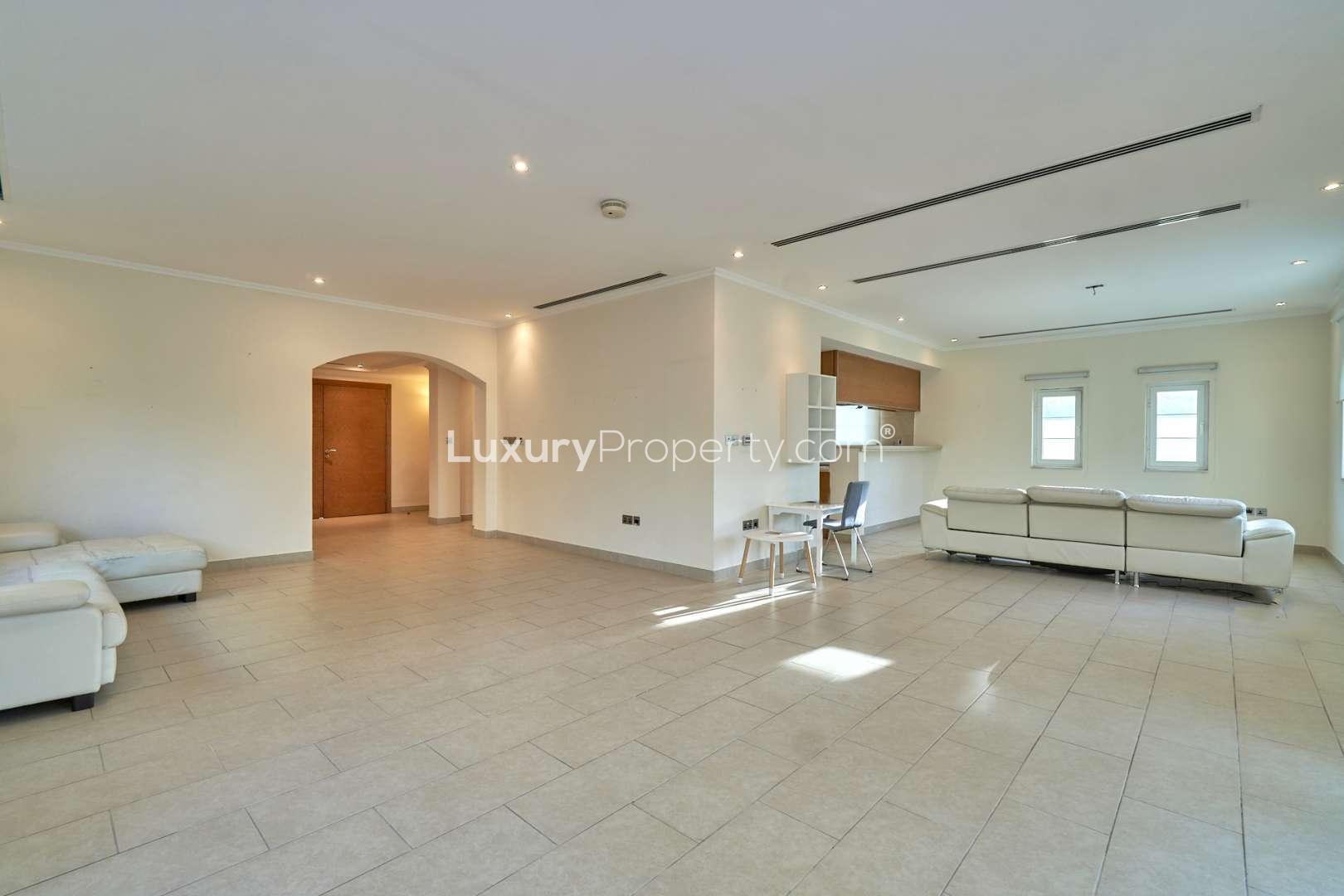 Spacious living room in 3-bedroom Legacy Villa, Jumeirah Park, with large windows and tiled floor