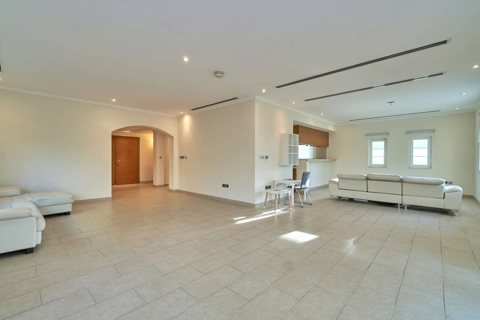 Spacious living room in 3-bedroom Legacy Villa, Jumeirah Park, with large windows and tiled floor