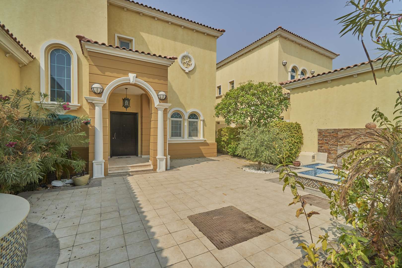 Spacious 3-bedroom villa entrance in Jumeirah Park's Legacy community with garden view