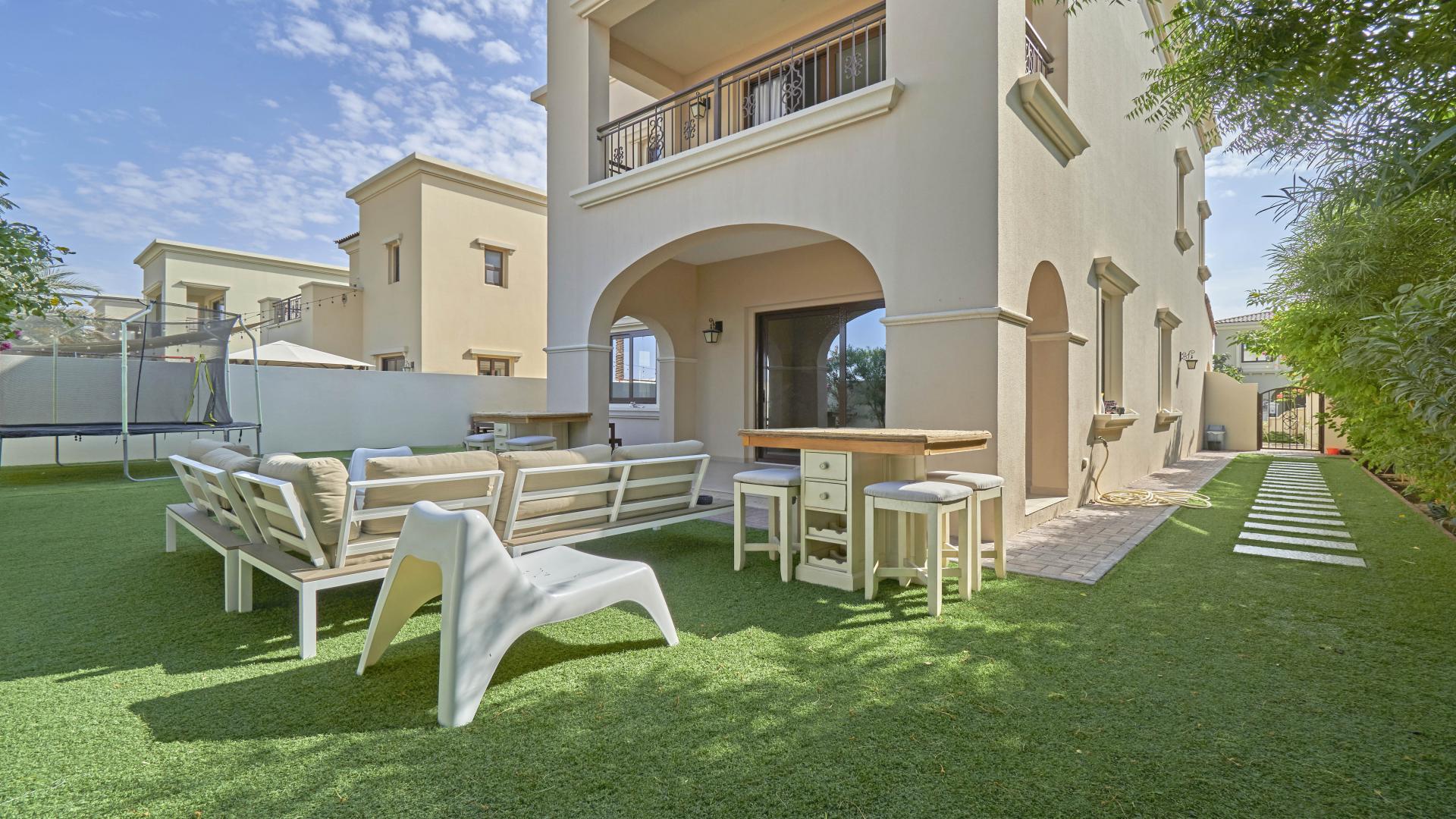 Bright living room in 3-bed villa, Arabian Ranches 2, featuring modern decor and garden view