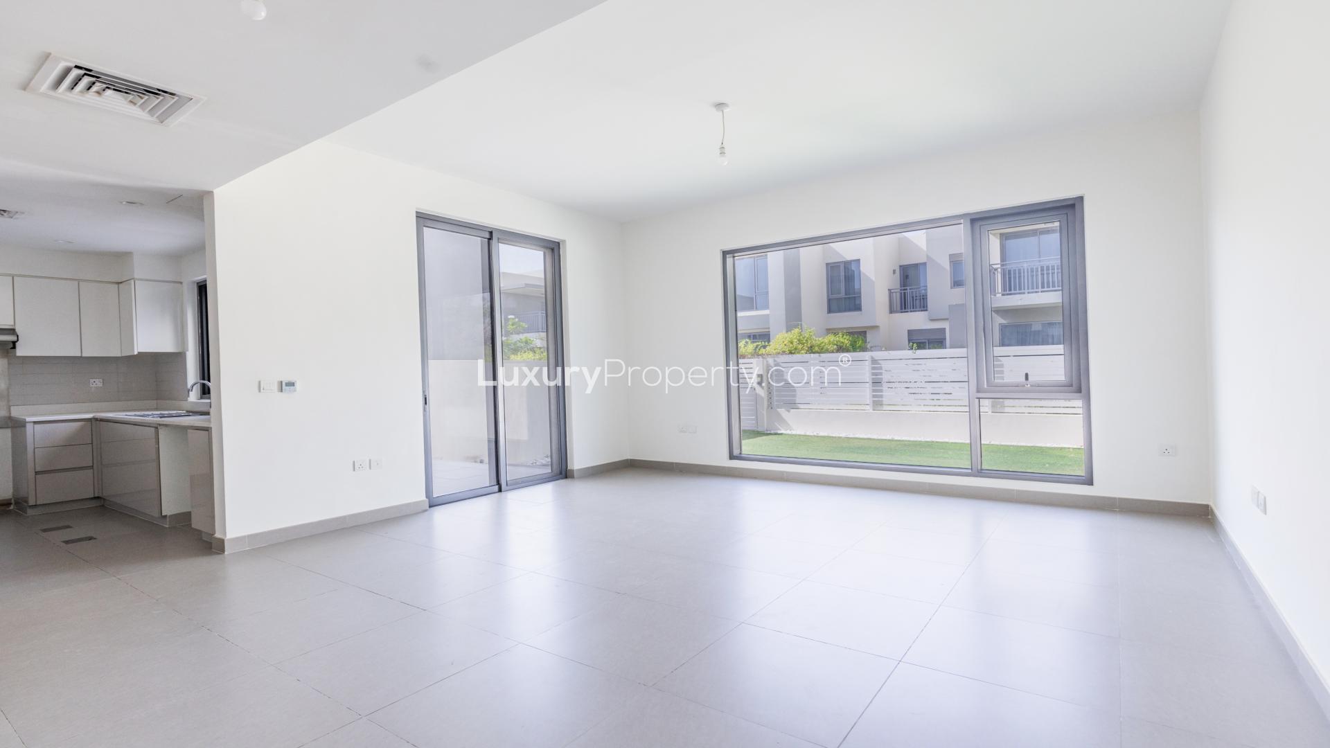 "Spacious backyard of 3-bedroom villa in Maple, Dubai Hills Estate, with modern landscaping.",Spacious living area in 3-bedroom villa, Maple, Dubai Hills Estate, with large windows and garden view