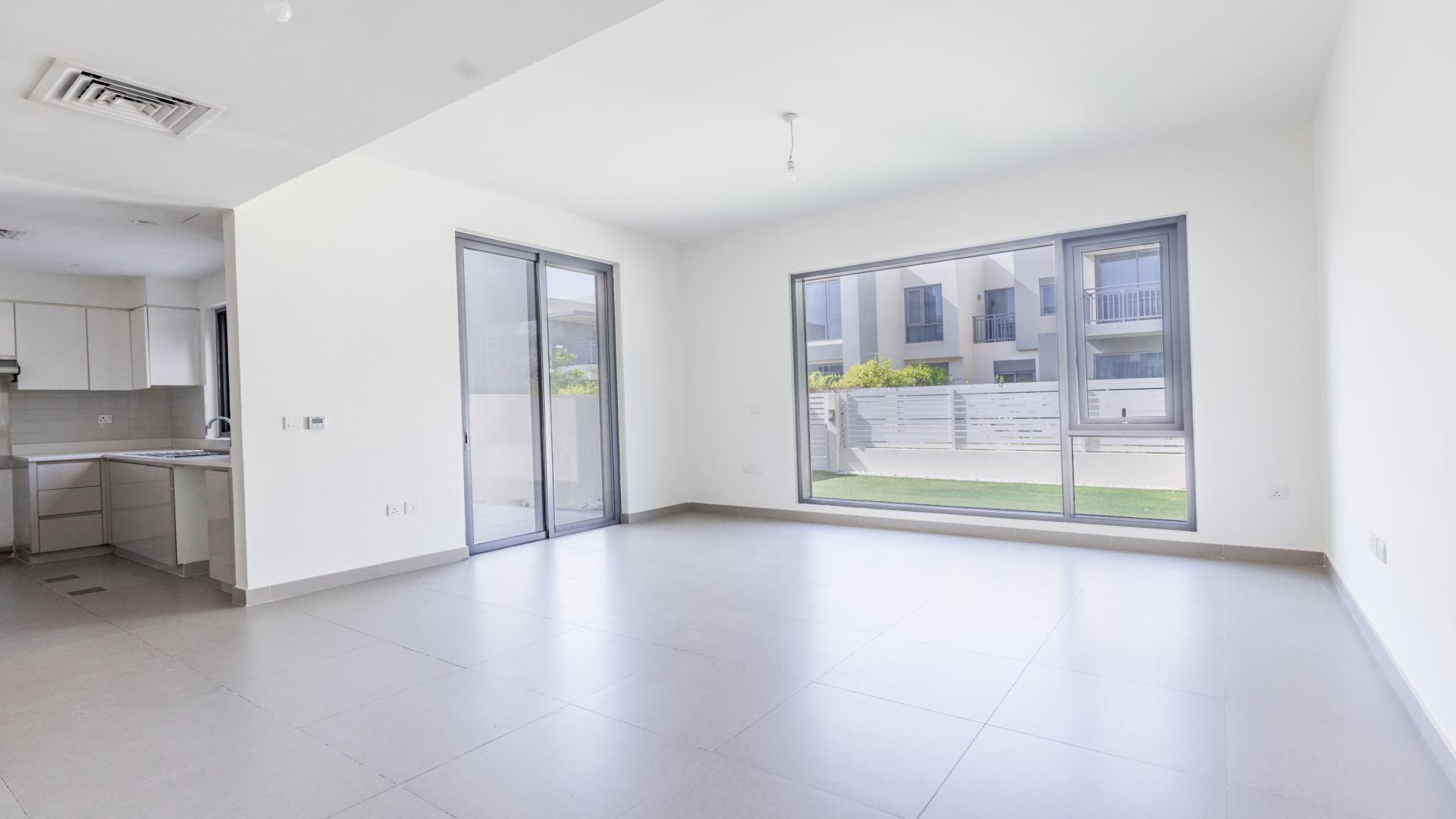 "Spacious backyard of 3-bedroom villa in Maple, Dubai Hills Estate, with modern landscaping.",Spacious living area in 3-bedroom villa, Maple, Dubai Hills Estate, with large windows and garden view