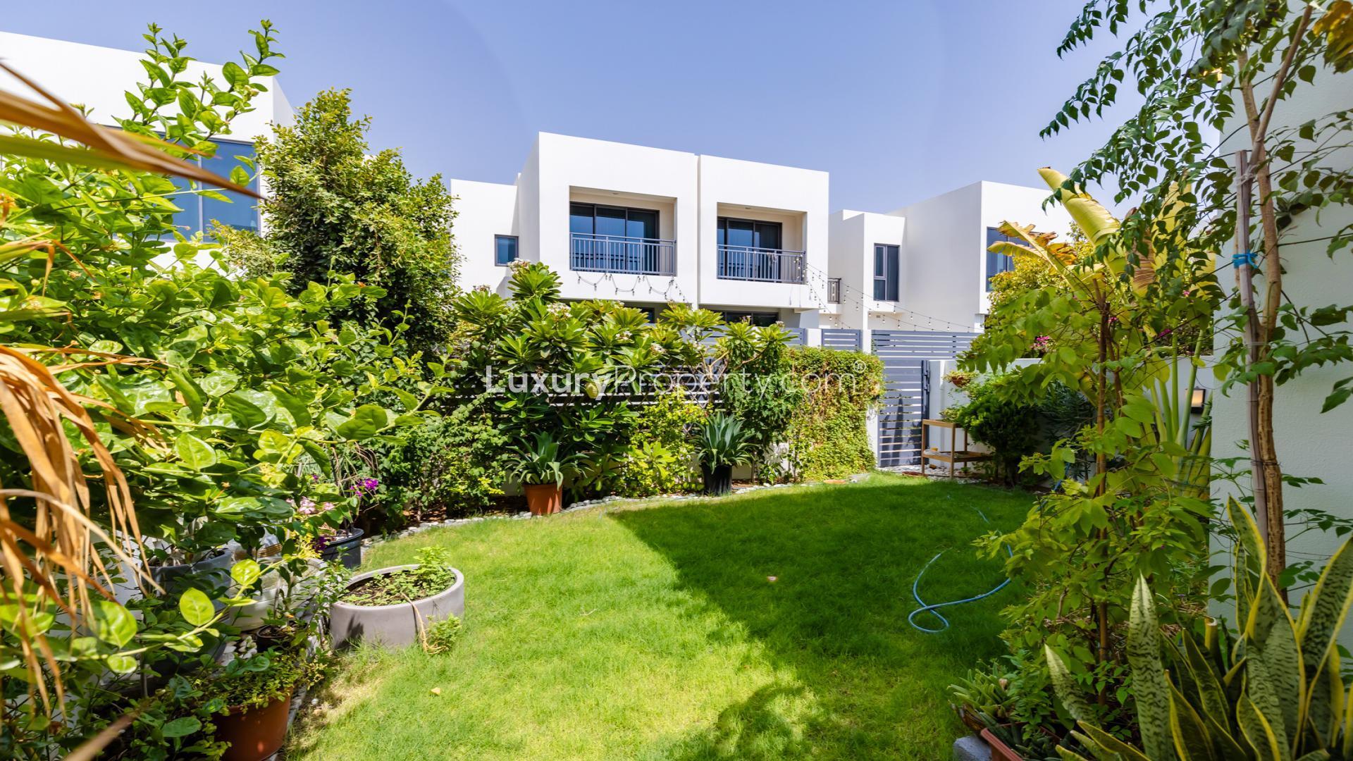 Living room in upgraded Maple 3 Villa, Dubai Hills Estate, with modern decor and garden view