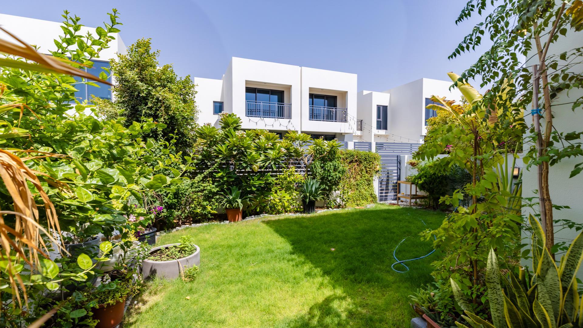 Living room in upgraded Maple 3 Villa, Dubai Hills Estate, with modern decor and garden view