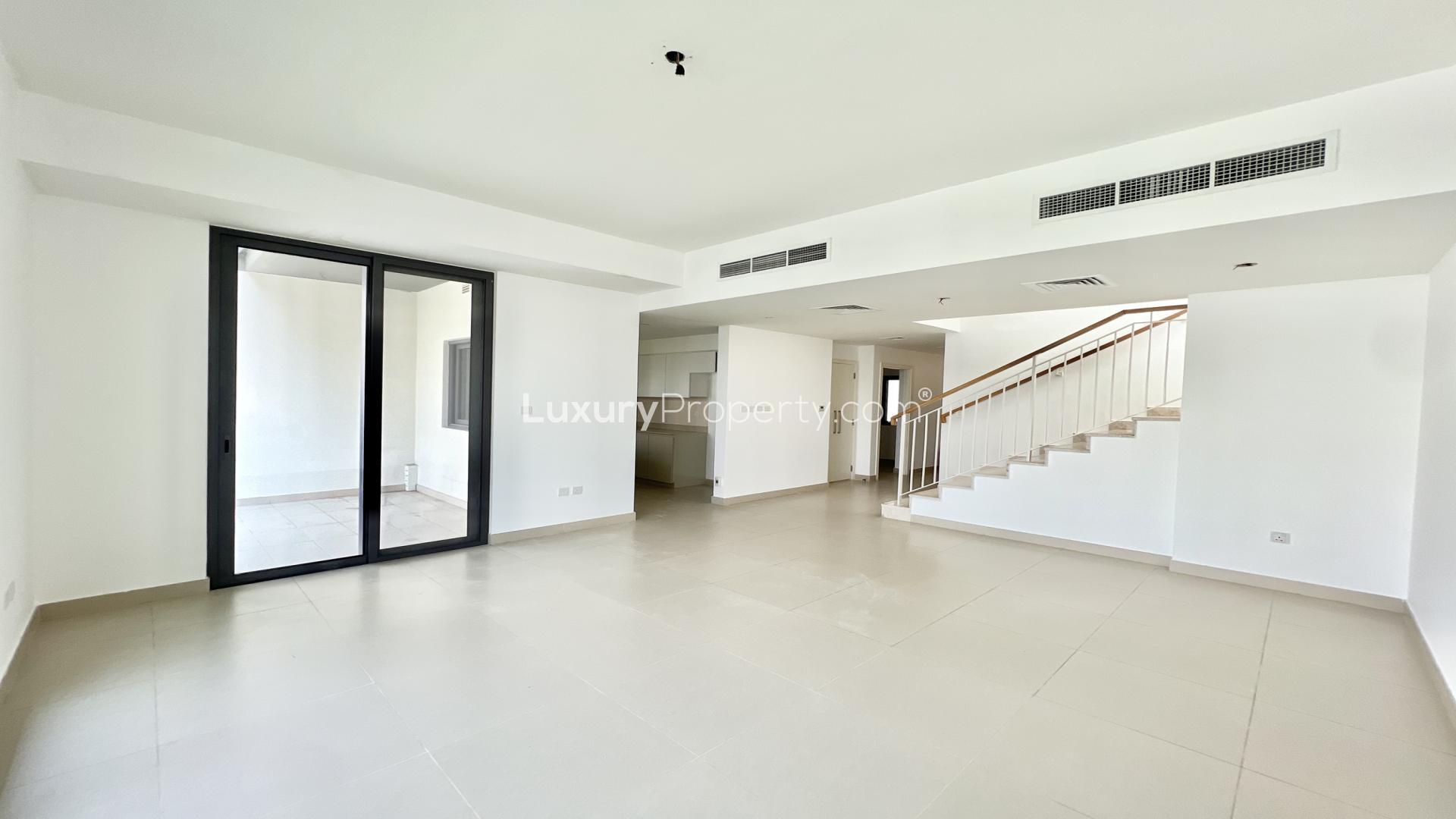 Bright living room in 3-bedroom villa, Maple 3, Dubai Hills Estate, with garden view