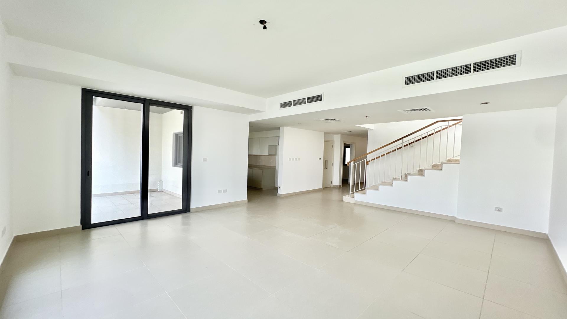 Bright living room in 3-bedroom villa, Maple 3, Dubai Hills Estate, with garden view