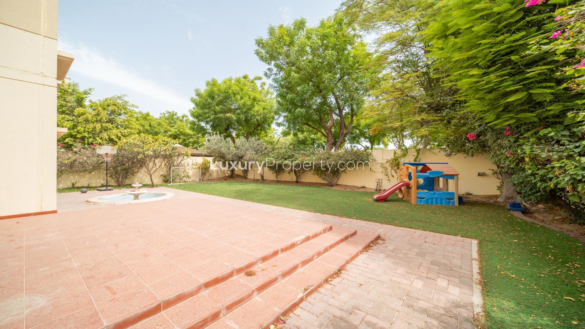 Backyard with patio, playground, and greenery in Meadows 9 villa for rent, LP14070