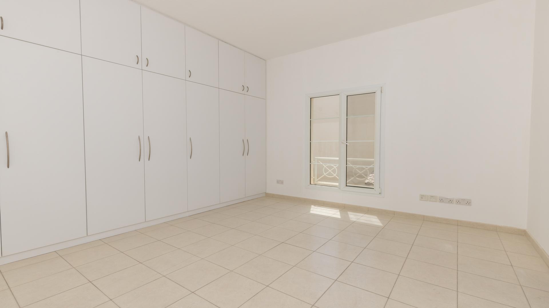 Empty bedroom with tiled floor and window in Meadows 6 villa, available for rent