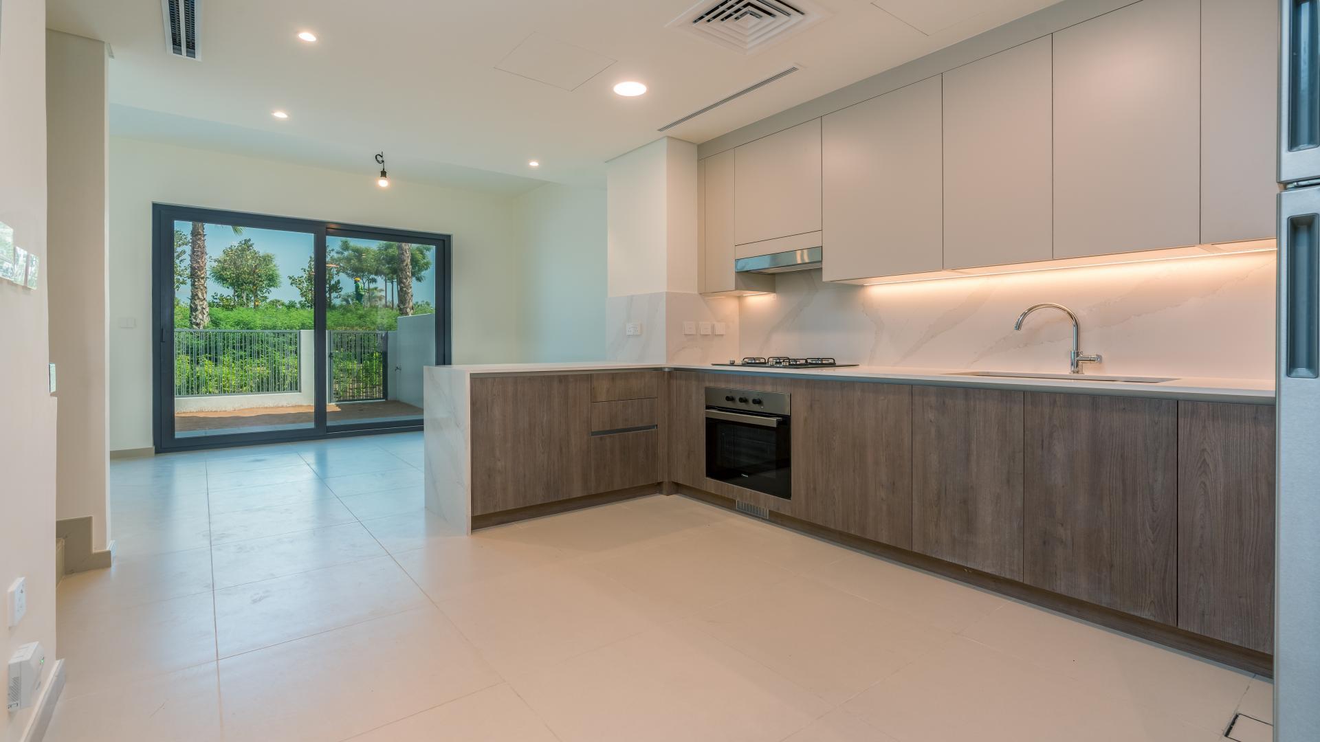 Modern kitchen and living area in 3-bedroom villa, Elan, Tilal Al Ghaf, for rent