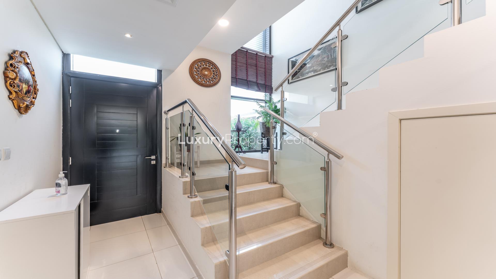 Modern living room in 3-bedroom villa, Rockwood, Damac Hills, with large window and stylish decor