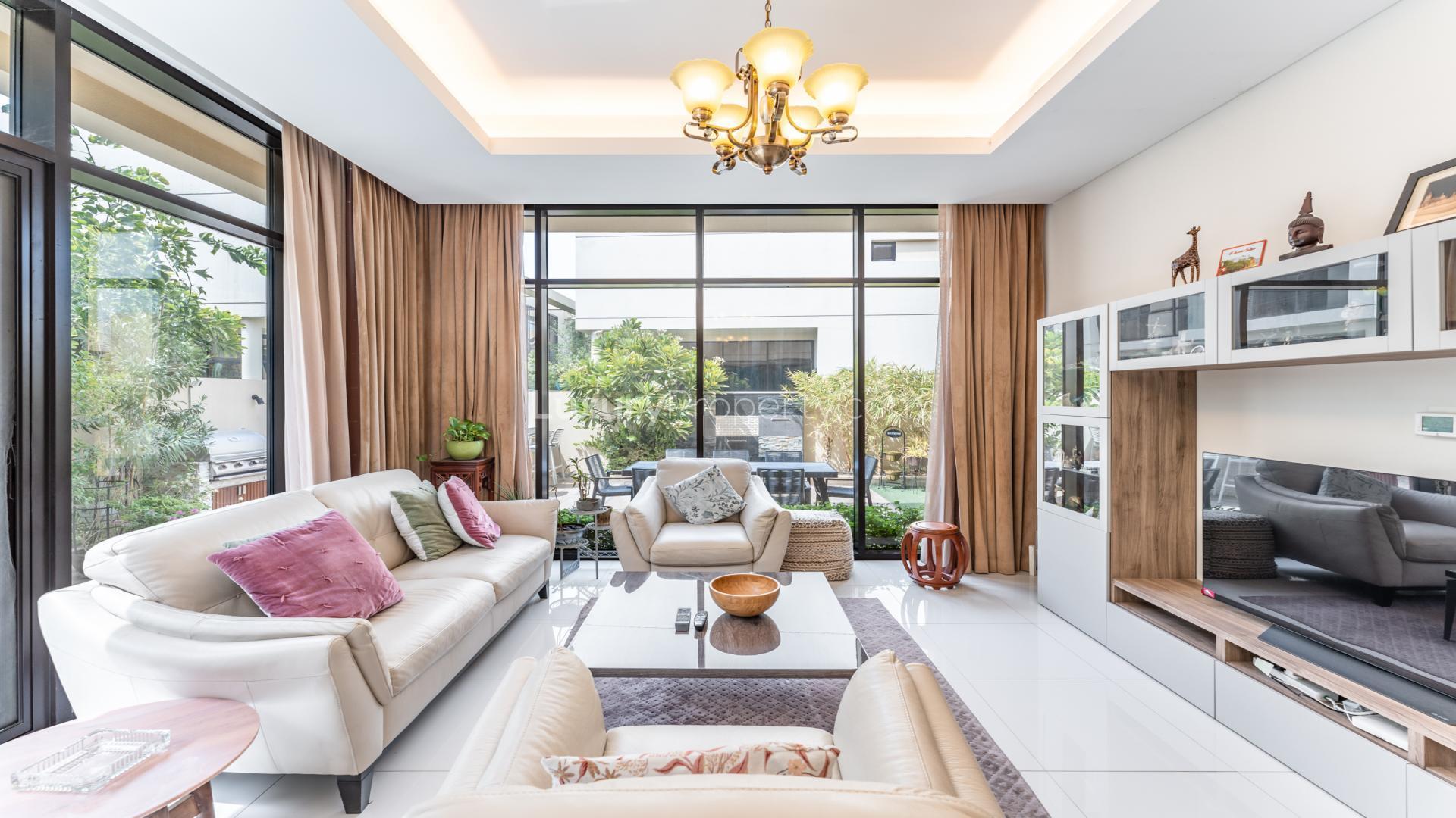 Modern kitchen with stainless steel appliances in Rockwood villa, Damac Hills