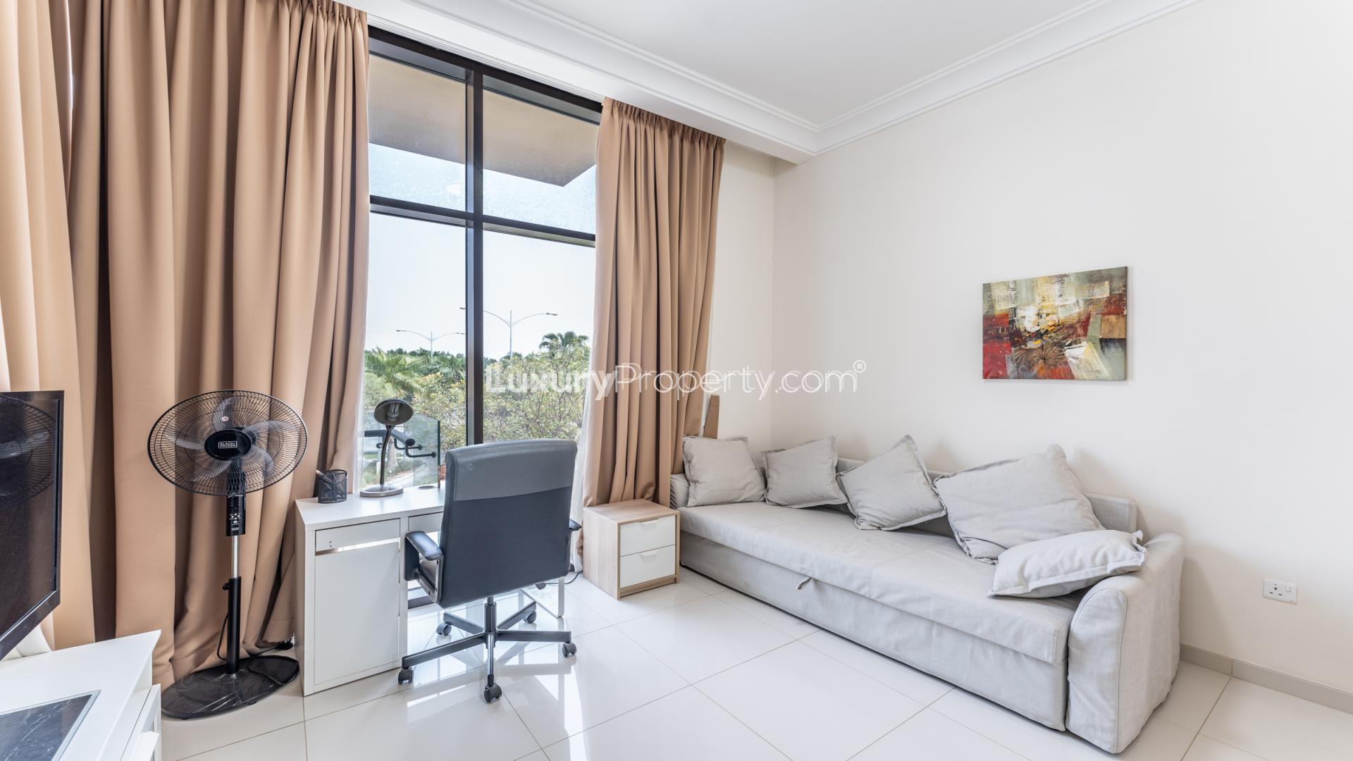 Luxurious living room in 3-bedroom villa, Rockwood, Damac Hills, featuring modern decor and garden view