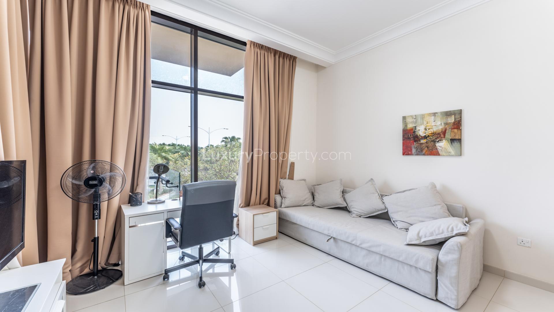 Luxurious living room in 3-bedroom villa, Rockwood, Damac Hills, featuring modern decor and garden view