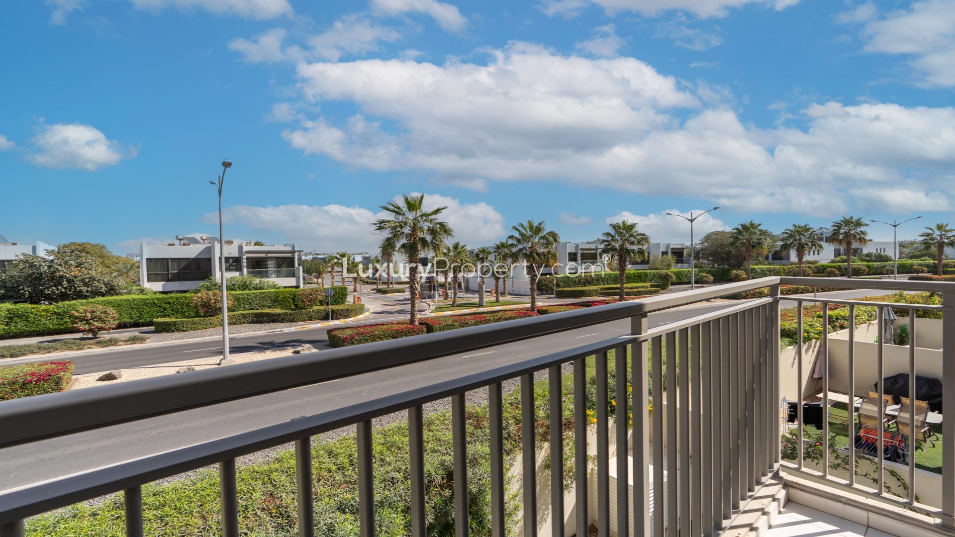 N/A,Balcony view of Odora community in Damac Hills 2 with lush greenery and palm trees