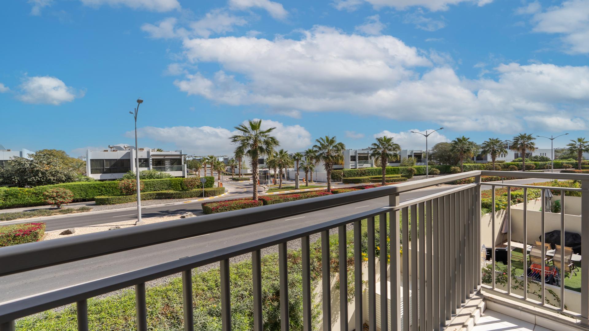 N/A,Balcony view of Odora community in Damac Hills 2 with lush greenery and palm trees