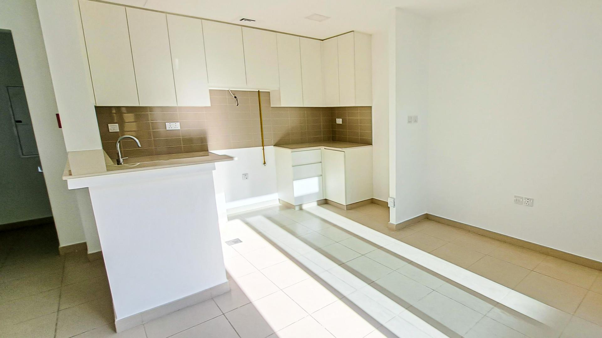 Outdoor patio with artificial grass at Naseem townhouse in Town Square, Dubai