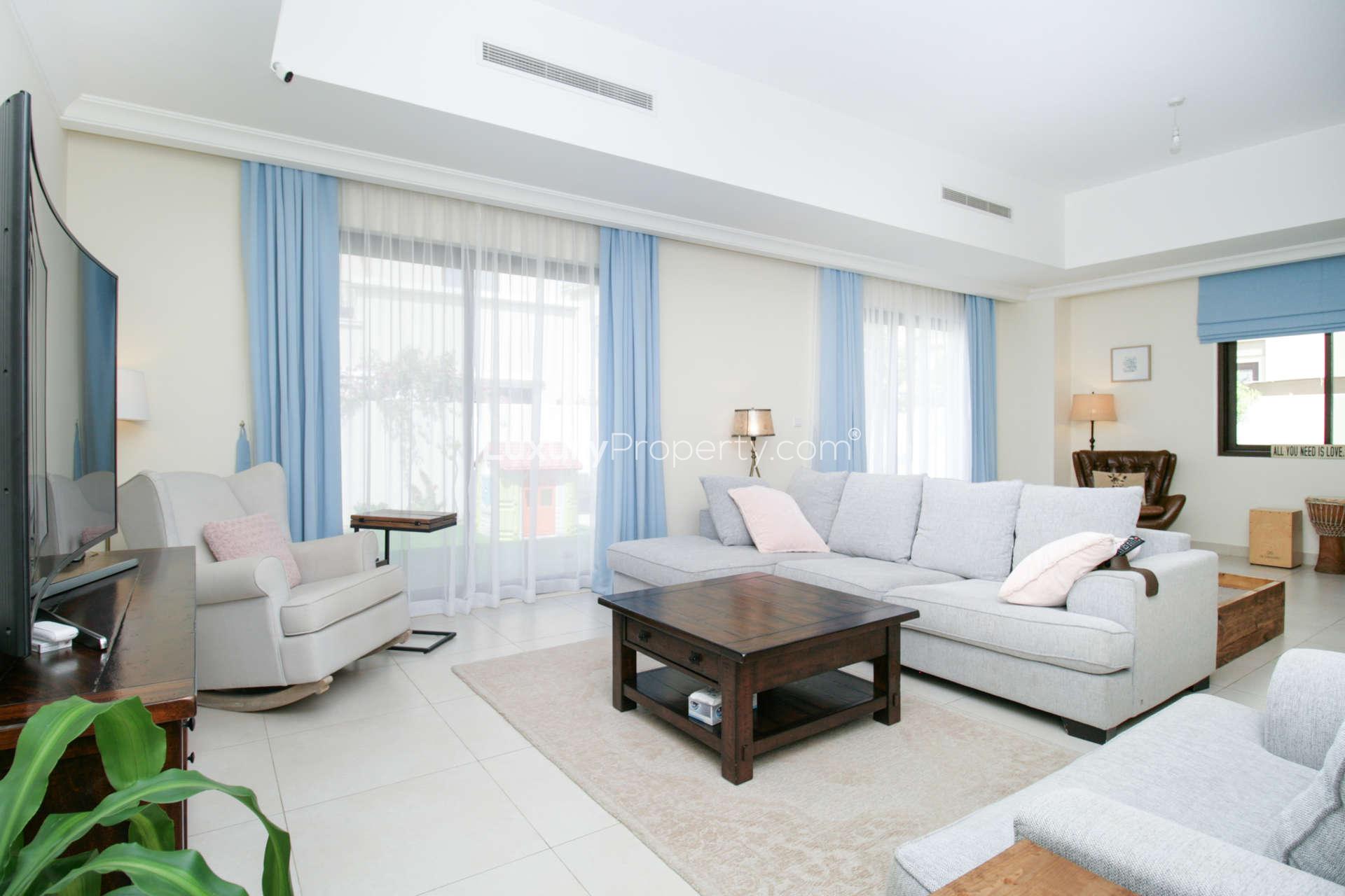 Living room in 3-bedroom villa, Palma, Arabian Ranches 2, with modern furniture and garden view