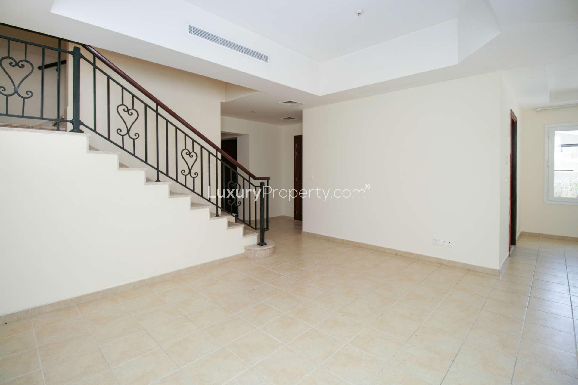Spacious living area with staircase in Palmera Villa, Arabian Ranches, for rent